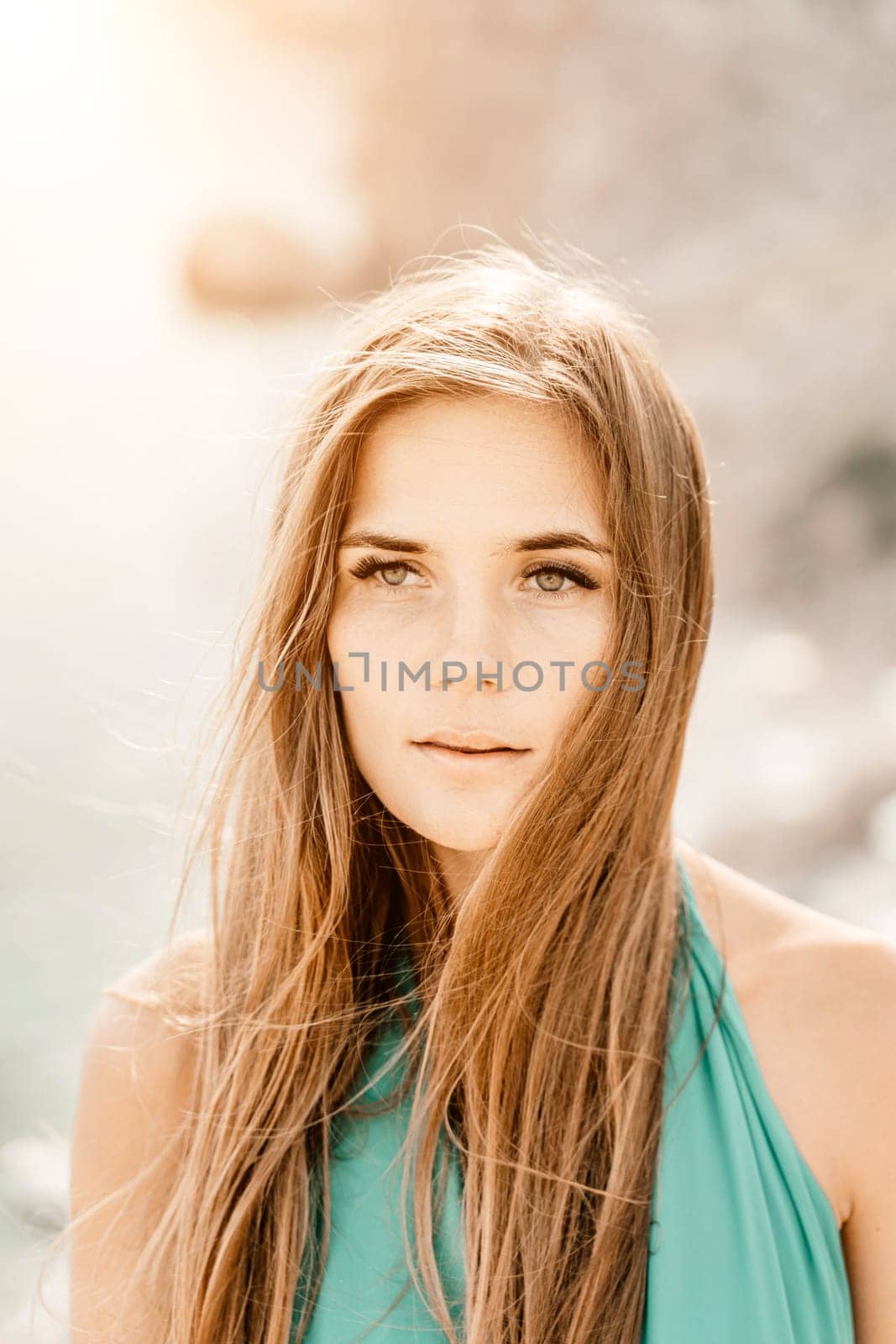 Woman sea green dress. Portrait of a happy woman with long hair in a long mint dress posing on a beach with calm sea bokeh lights on sunny day. Girl on the nature on blue sky background. by Matiunina