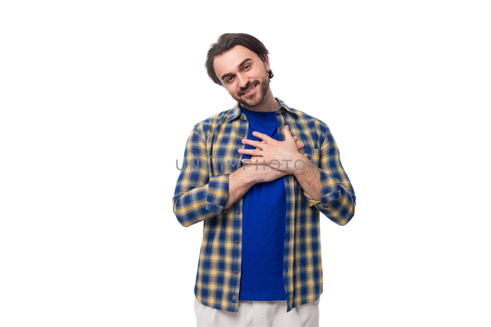 young stylish handsome caucasian brunette with a beard is dressed in a blue plaid shirt and t-shirt by TRMK