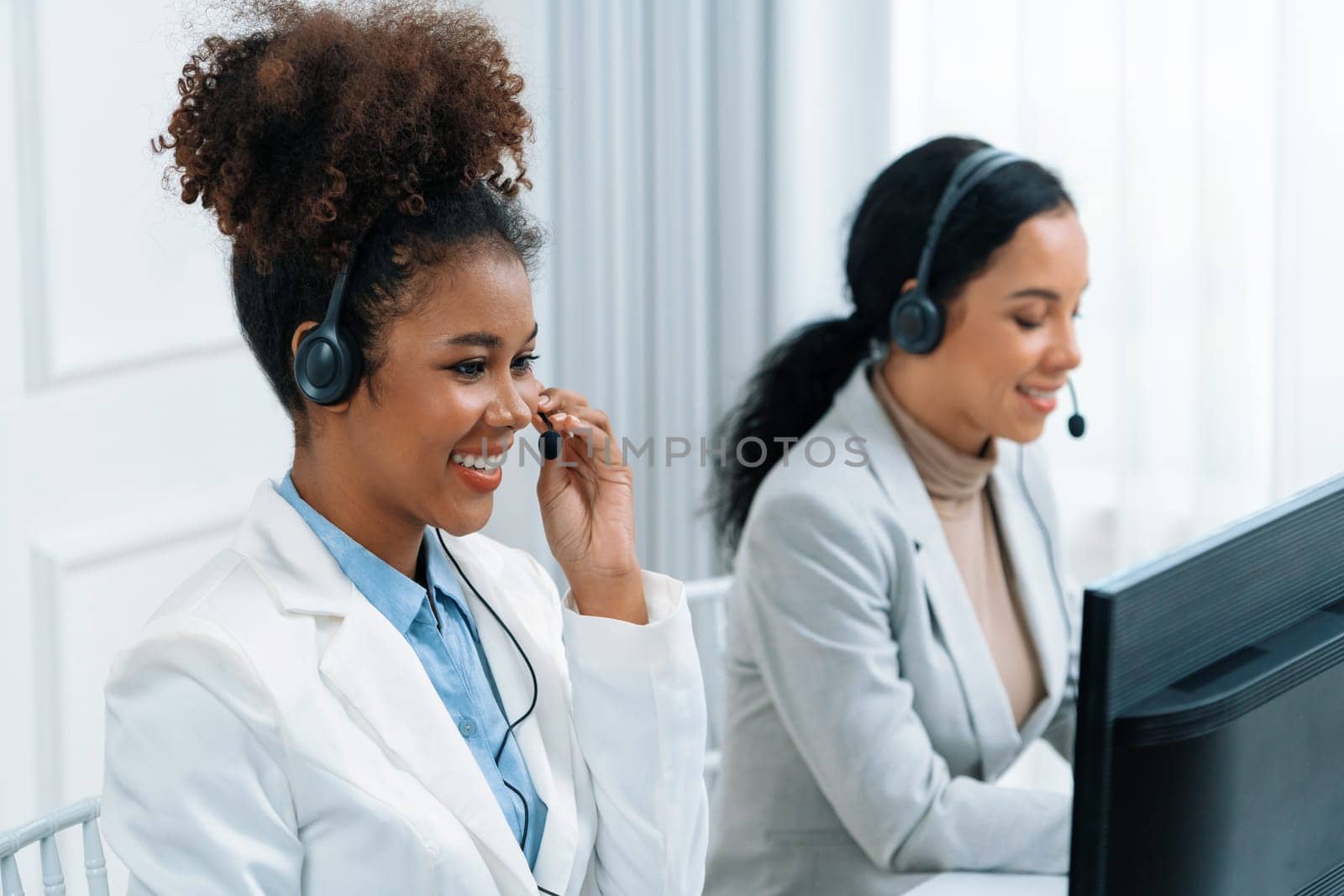 Business people wearing headset working in crucial office by biancoblue