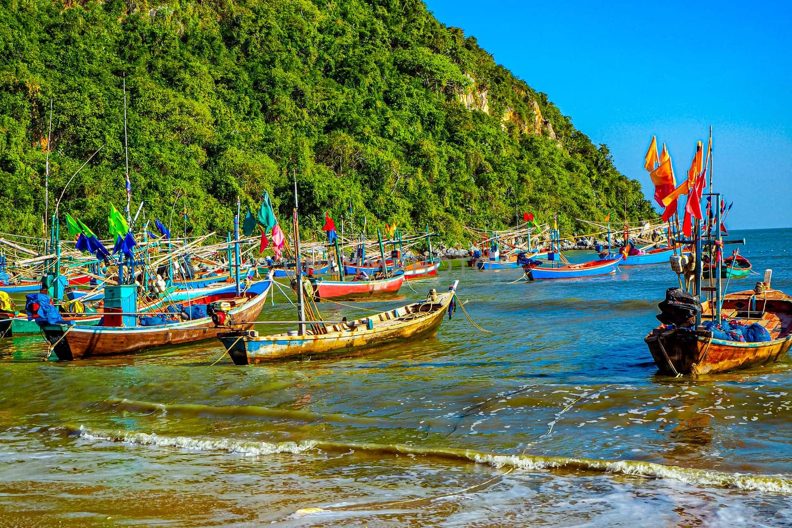 Vibrant Reflections Traditional Fishing Boat at the Shores of Thailand