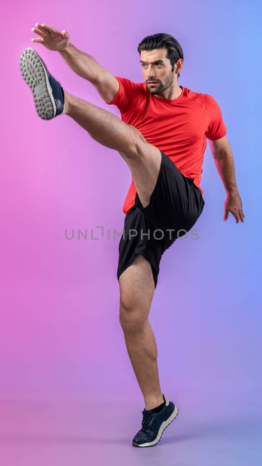 Full body length gaiety shot athletic and sporty young man with fitness in cardio exercise, kicking position posture on isolated background. Healthy active and body care lifestyle.