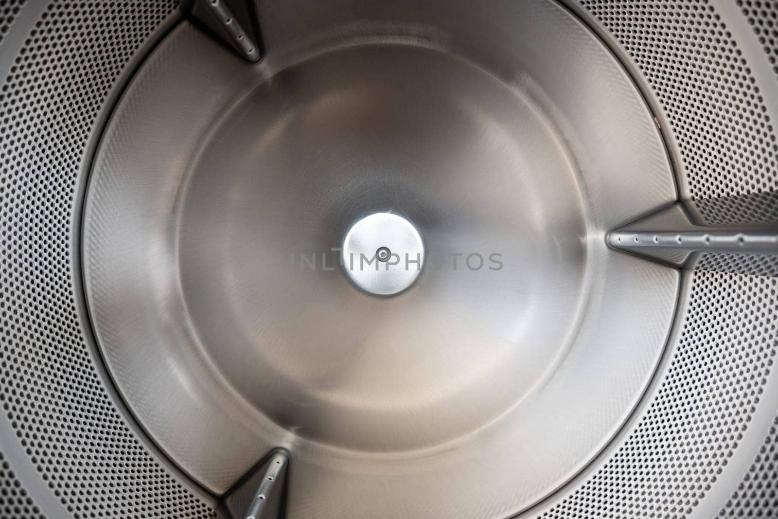 Close up Inside of washing machine tub with opened door is made of stainless steel by Sorapop