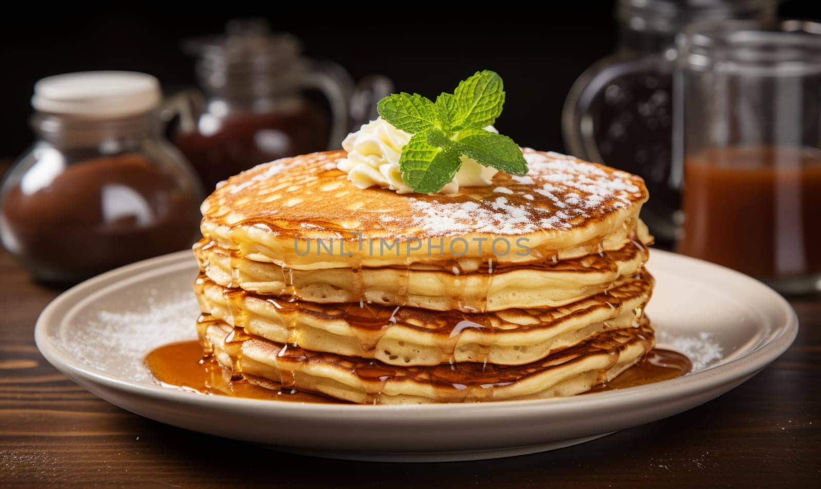 Breakfast food - stack of pancakes with syrup and butter.