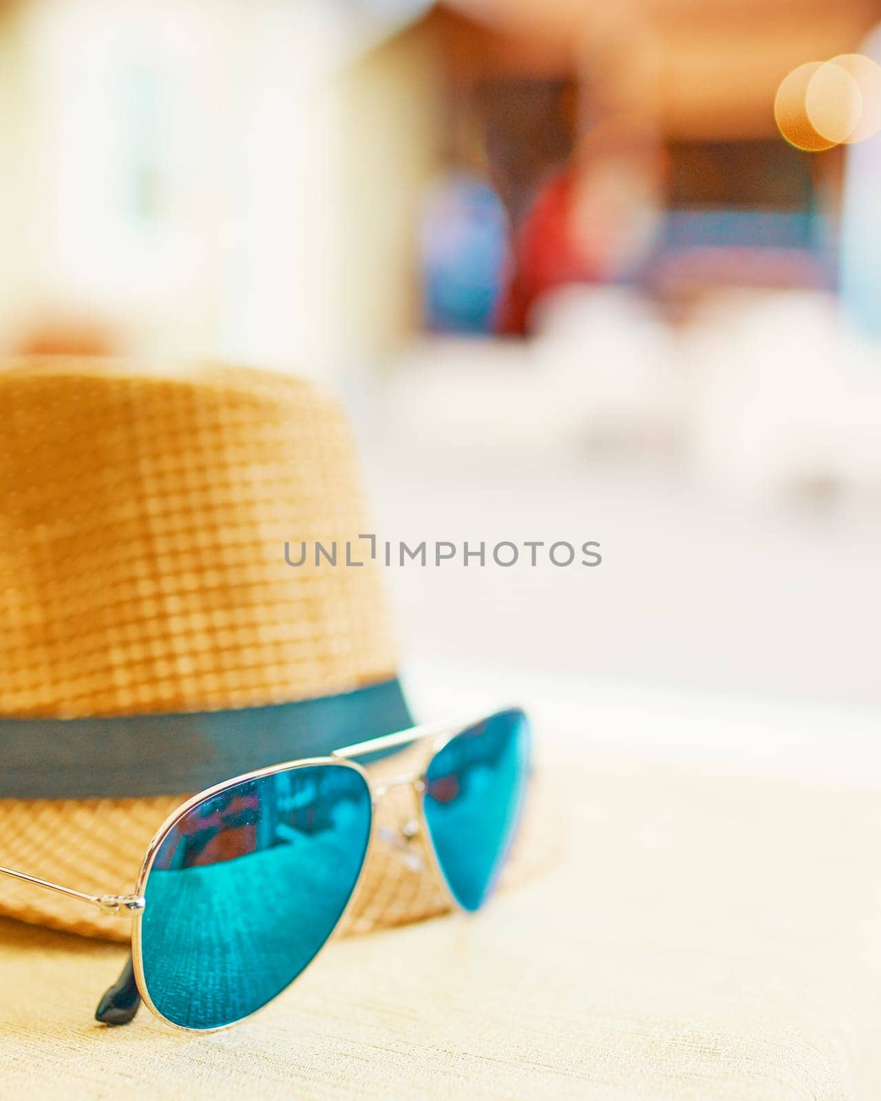 Straw hat on a hot day off with green sunglasses