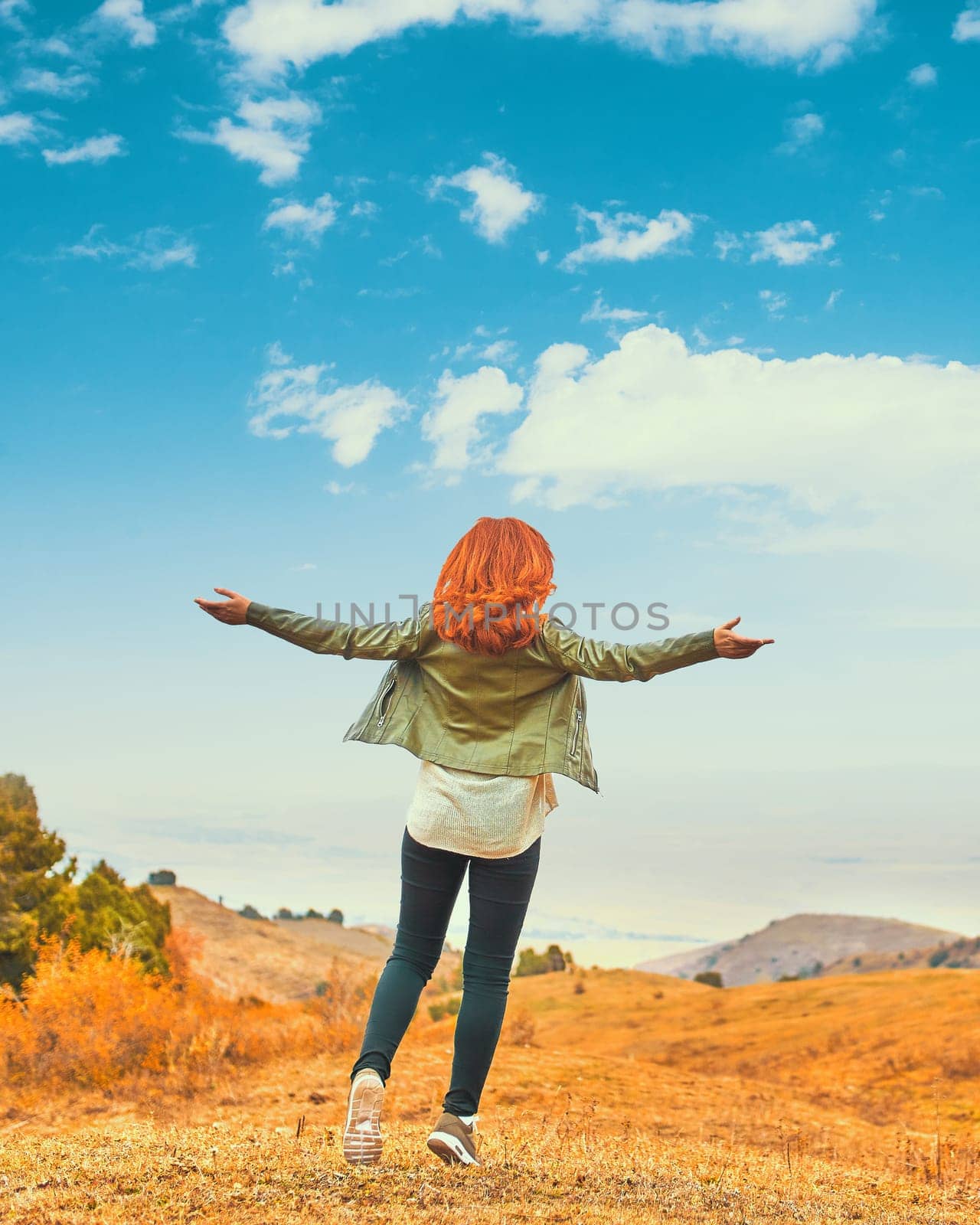 Beauty woman outdoors enjoying nature. Teenage girl enjoy with sunshine in field.