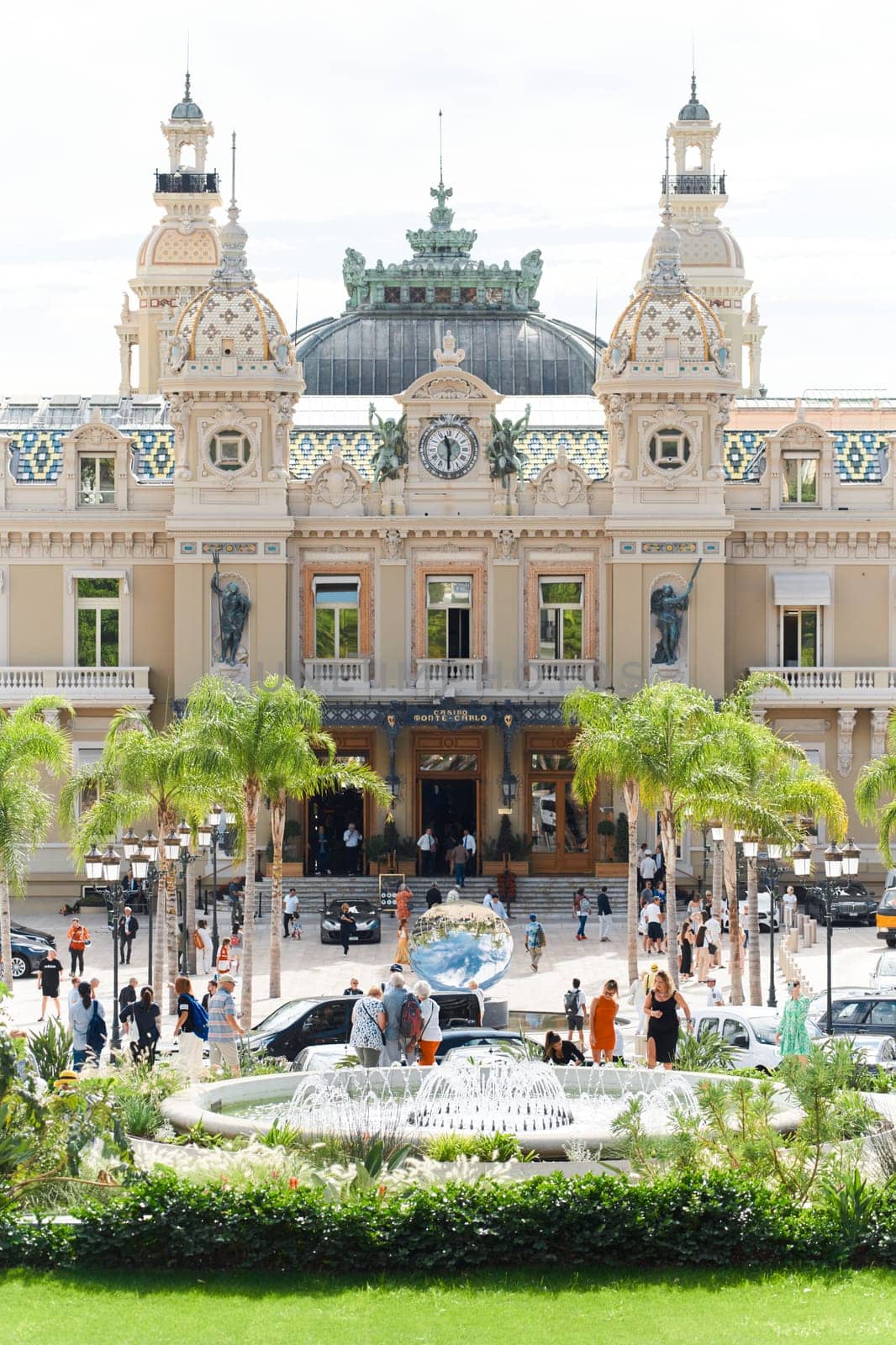 Monaco, Monte-Carlo, 21 October 2022 - Square Casino Monte-Carlo at sunny day, wealth life, tourists take pictures of the landmark, pine trees, blue sky. High quality photo