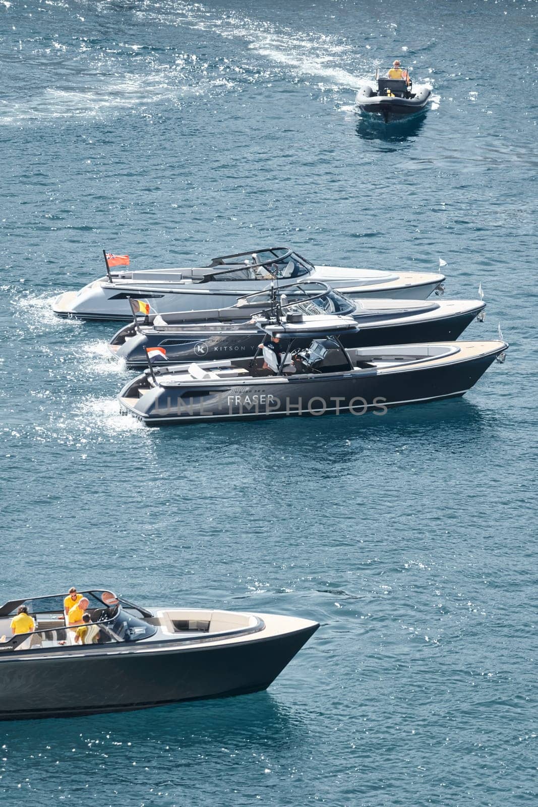 Monaco, Monte Carlo, 27 September 2022 - a boat with guests of yacht brokers departs from the shore in the largest fair exhibition in the world yacht show MYS, port Hercules, rich clients, sunny by vladimirdrozdin