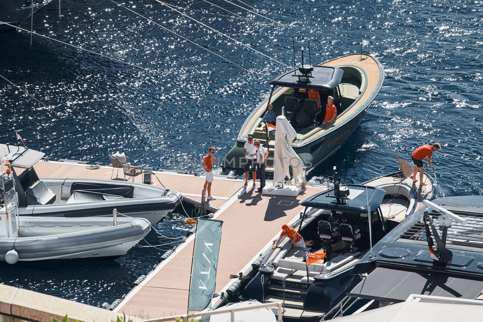 Monaco, Monte Carlo, 27 September 2022 - a boat with guests of yacht brokers departs from the shore in the largest fair exhibition in the world yacht show MYS, port Hercules, rich clients, sunny. High quality photo