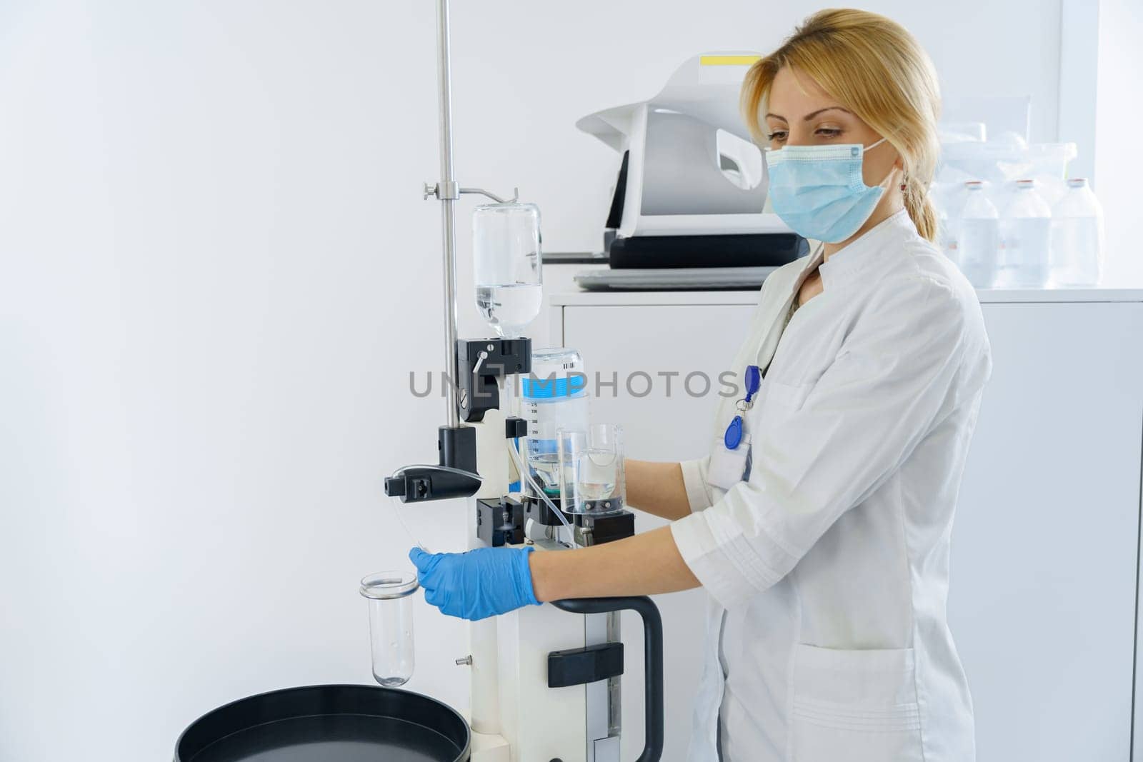 Woman technologist preparing CT Scan Machine in hospital before procedure. High quality photo