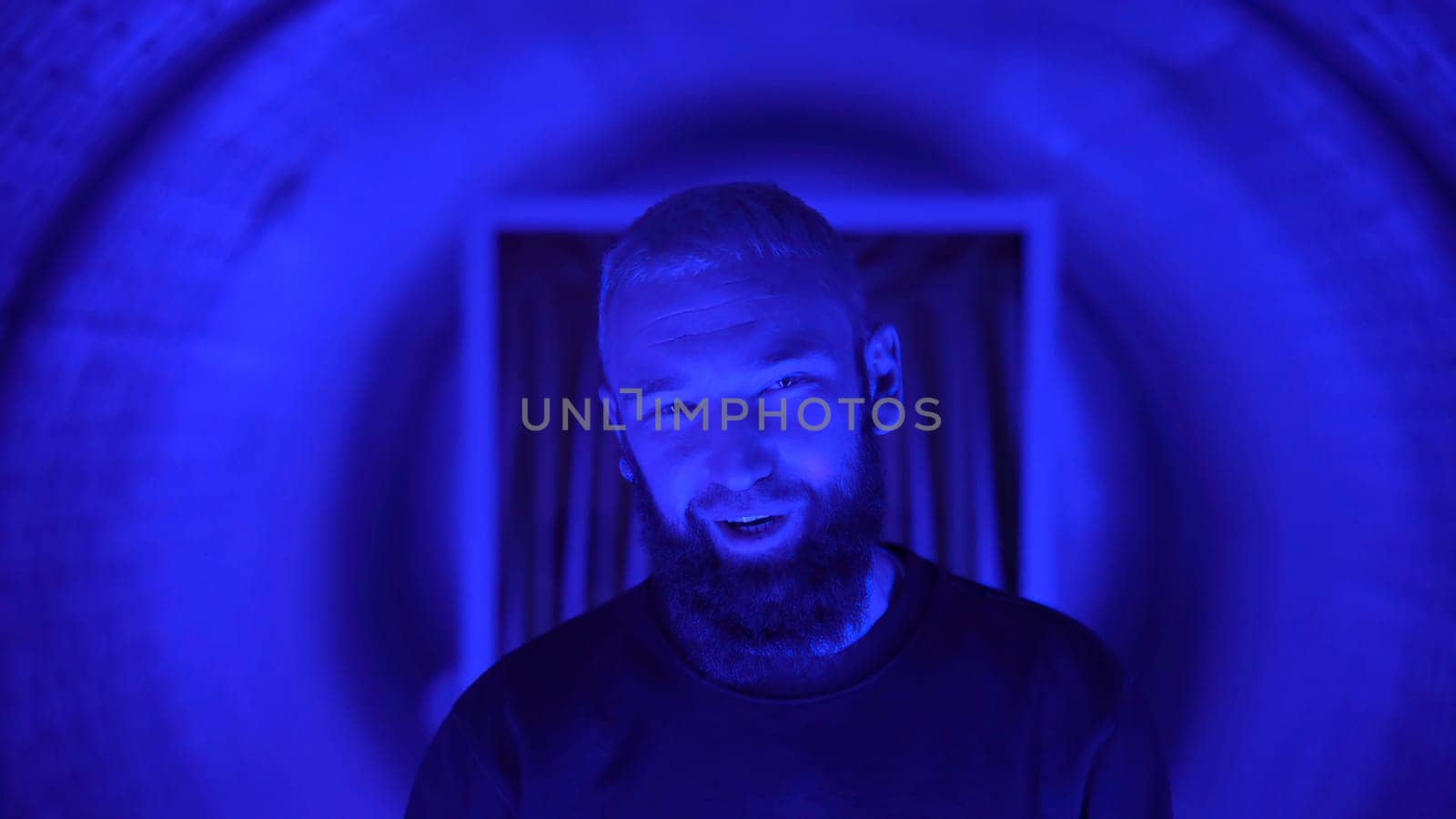 Neon light studio close-up portrait of serious man model . High quality photo