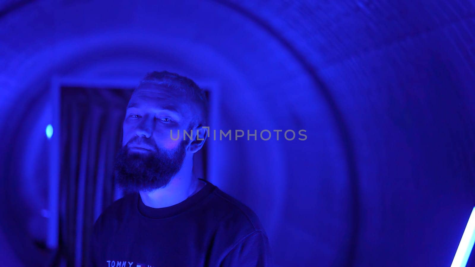 Neon light studio close-up portrait of serious man model . High quality photo