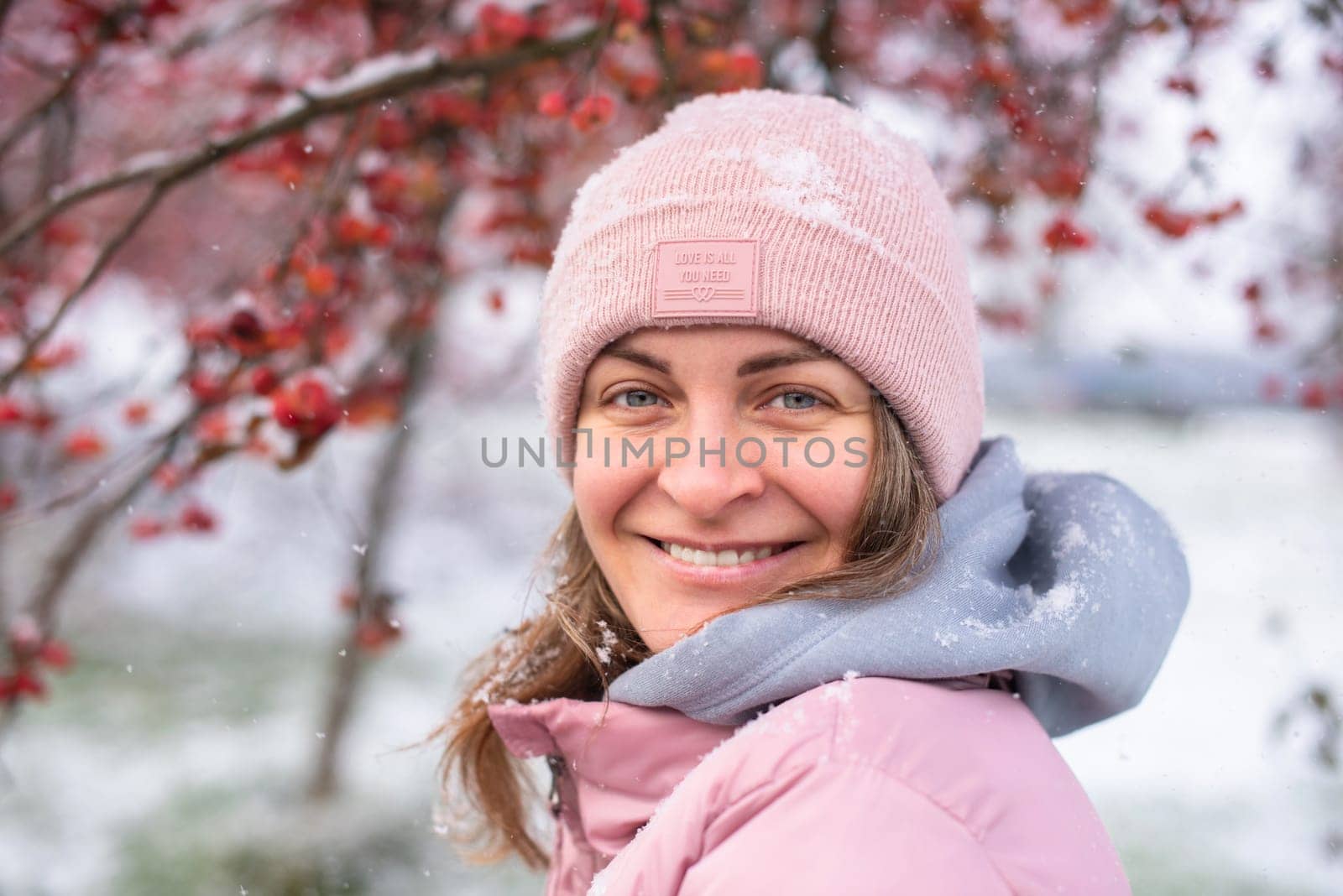 Winter Elegance: Portrait of a Beautiful Girl in a Snowy European Village. Winter lifestyle portrait of cheerful pretty girl. Smiling and having fun in the snow park. Snowflakes falling down. Christmas Radiance: Capturing Winter Elegance in the Snowy Ambiance of a European Village by Andrii_Ko