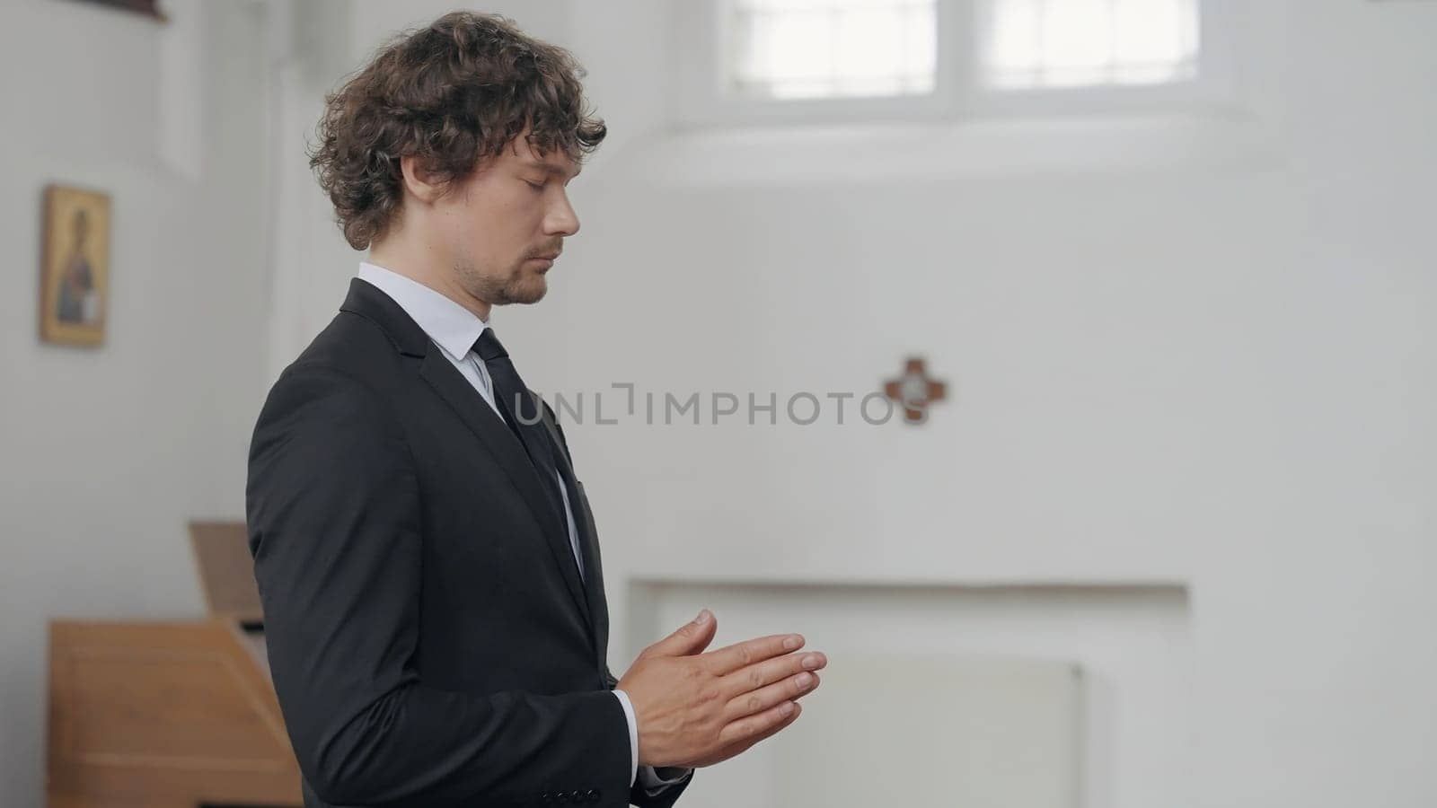 A handsome,worried man. Action.The groom in a suit in the wedding hall shifts his hands from nerves. High quality 4k footage