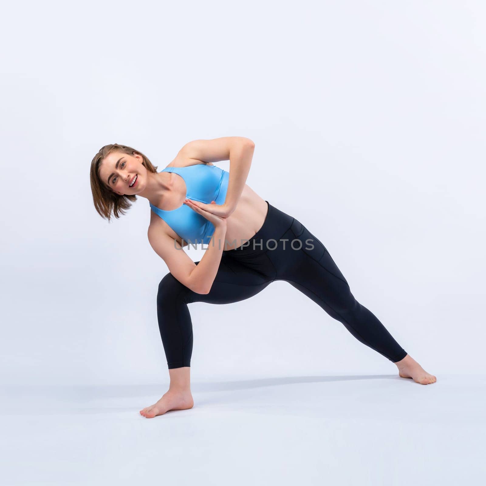 Full body length gaiety shot athletic and sporty woman doing healthy and meditative yoga exercise workout posture on isolated background. Healthy active and body care lifestyle