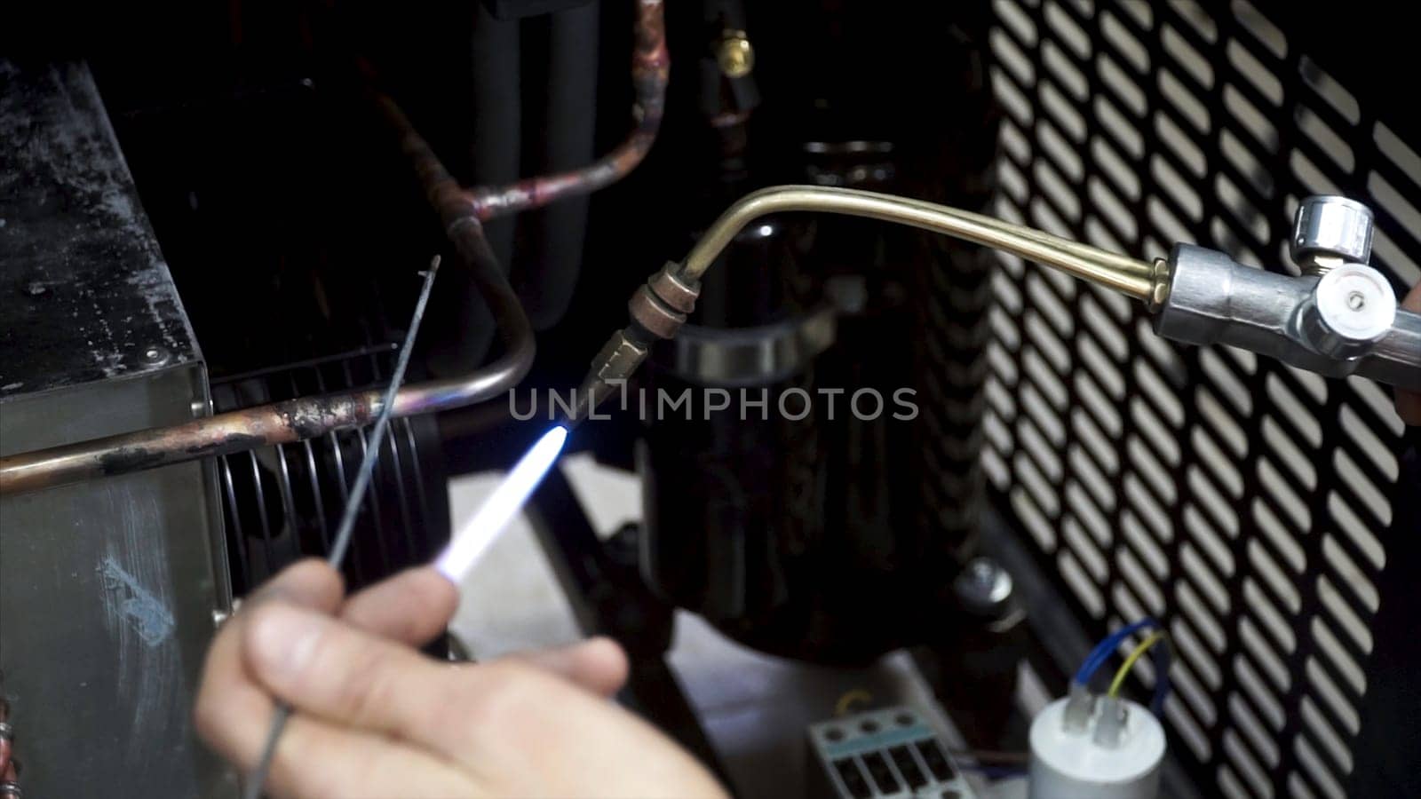 Handle during Welding process uses torch to make sparks closeup during manufacture of Metal equipment. Close - up conduct welding of metal parts, metal droplets are beautifully sprinkled in all directions.