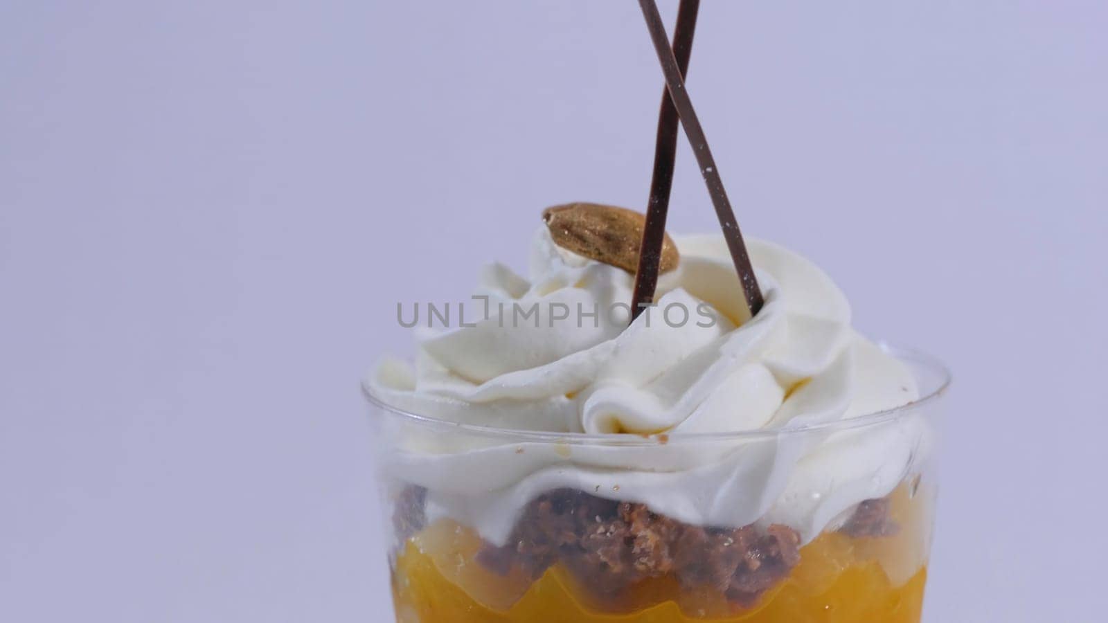 Vanilla sundae ice cream in cup on background. Ice cream in a glass with cream, closeup.
