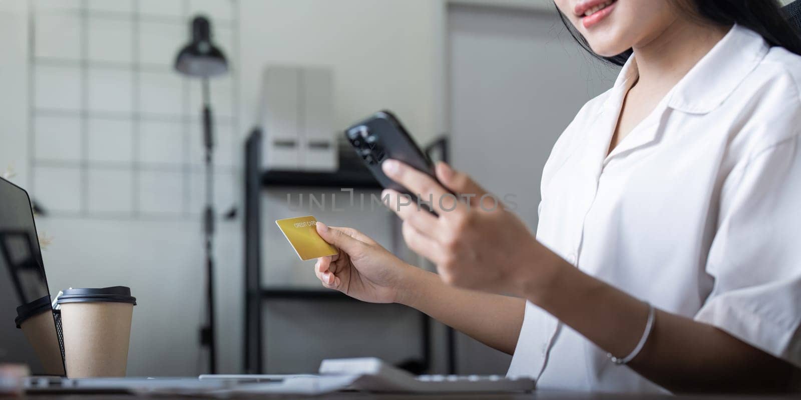 Woman on desk with laptop, credit card and ecommerce payment for online shopping at home. Happy female customer, digital bank app and sale on store website with internet banking by nateemee