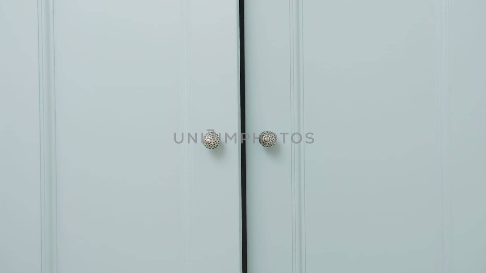 Close-up of light cabinet closes. Creative. doors of large wardrobe are closing. Doors of large cabinet slowly close.