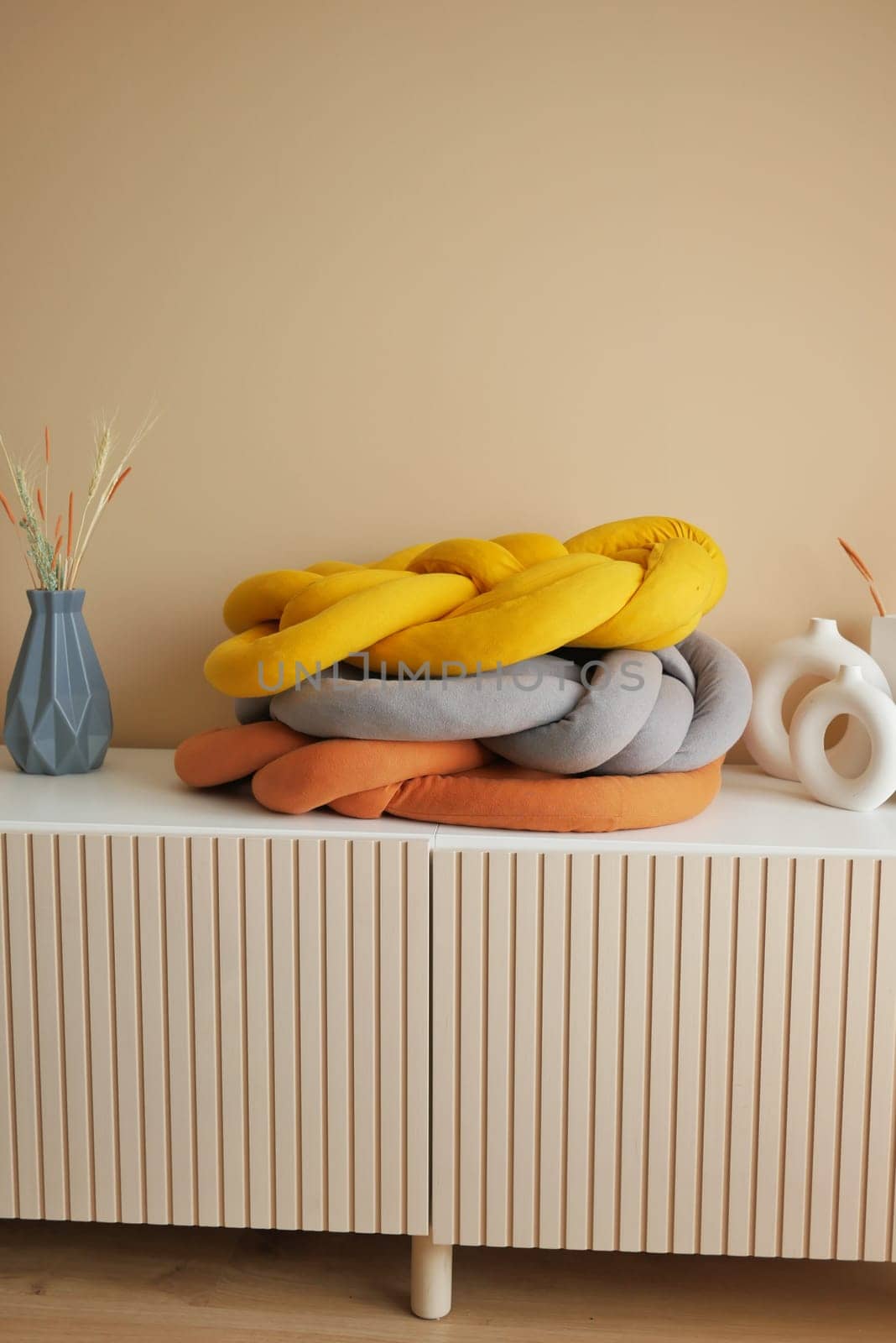 single orange color pillow on a decorative table .