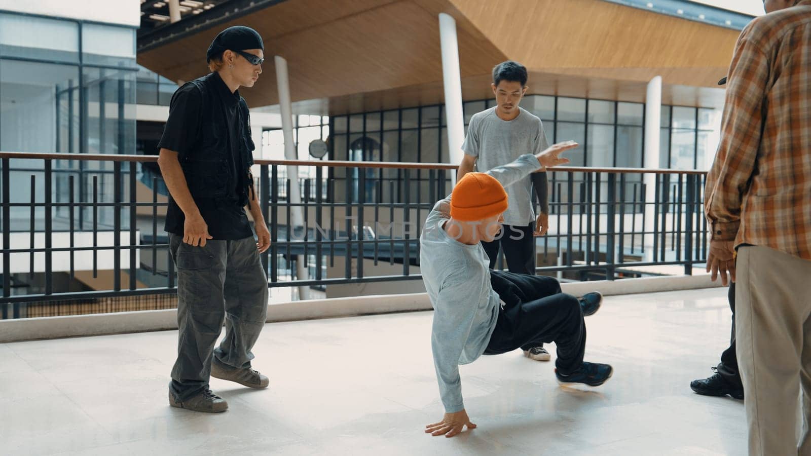 Hip hop team dance break dance while multicultural friend surrounded and clapping hands to cheer or encourage his friend to dance. Active and energetic street dance. Outdoor sport 2024. Endeavor.