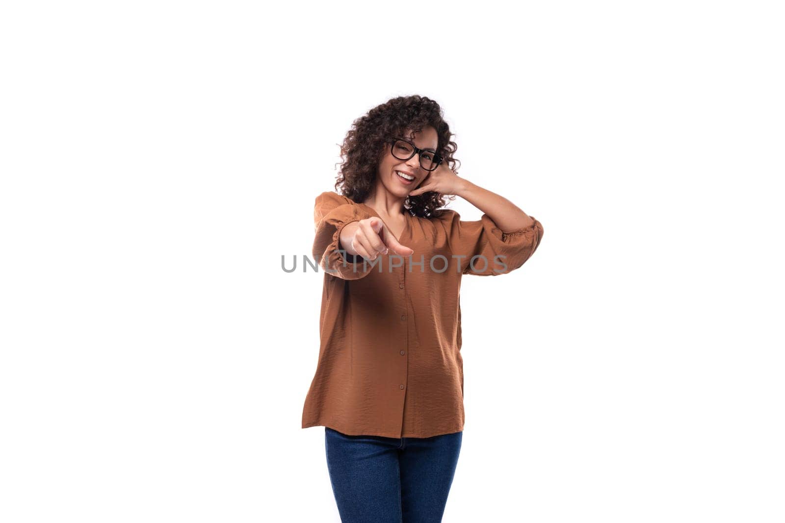 young successful curly brunette secretary woman dressed in brown blouse.