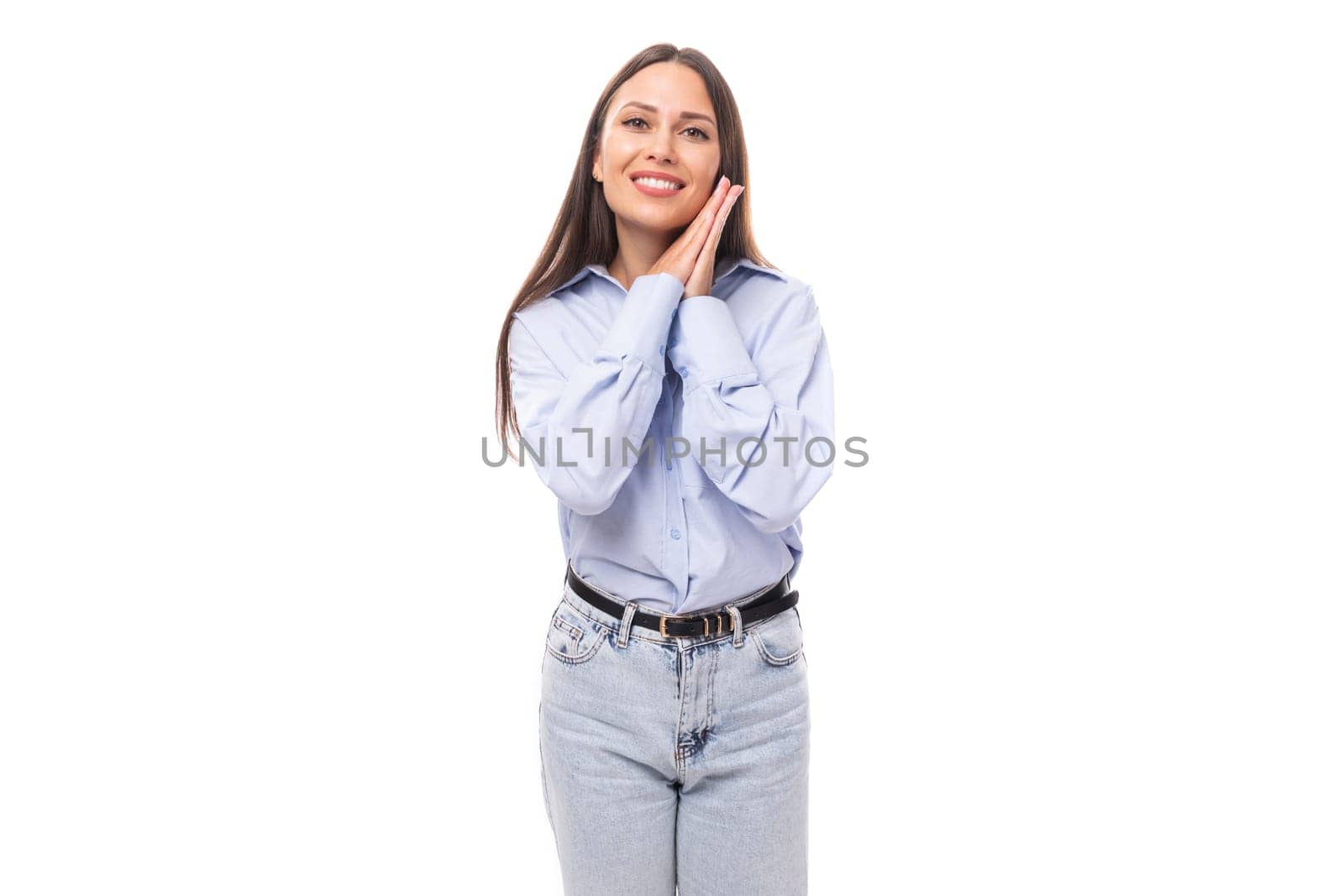 portrait of a stylish well-groomed young brunette caucasian woman with straight hair dressed in a sky blue blouse on a white background with copy space by TRMK