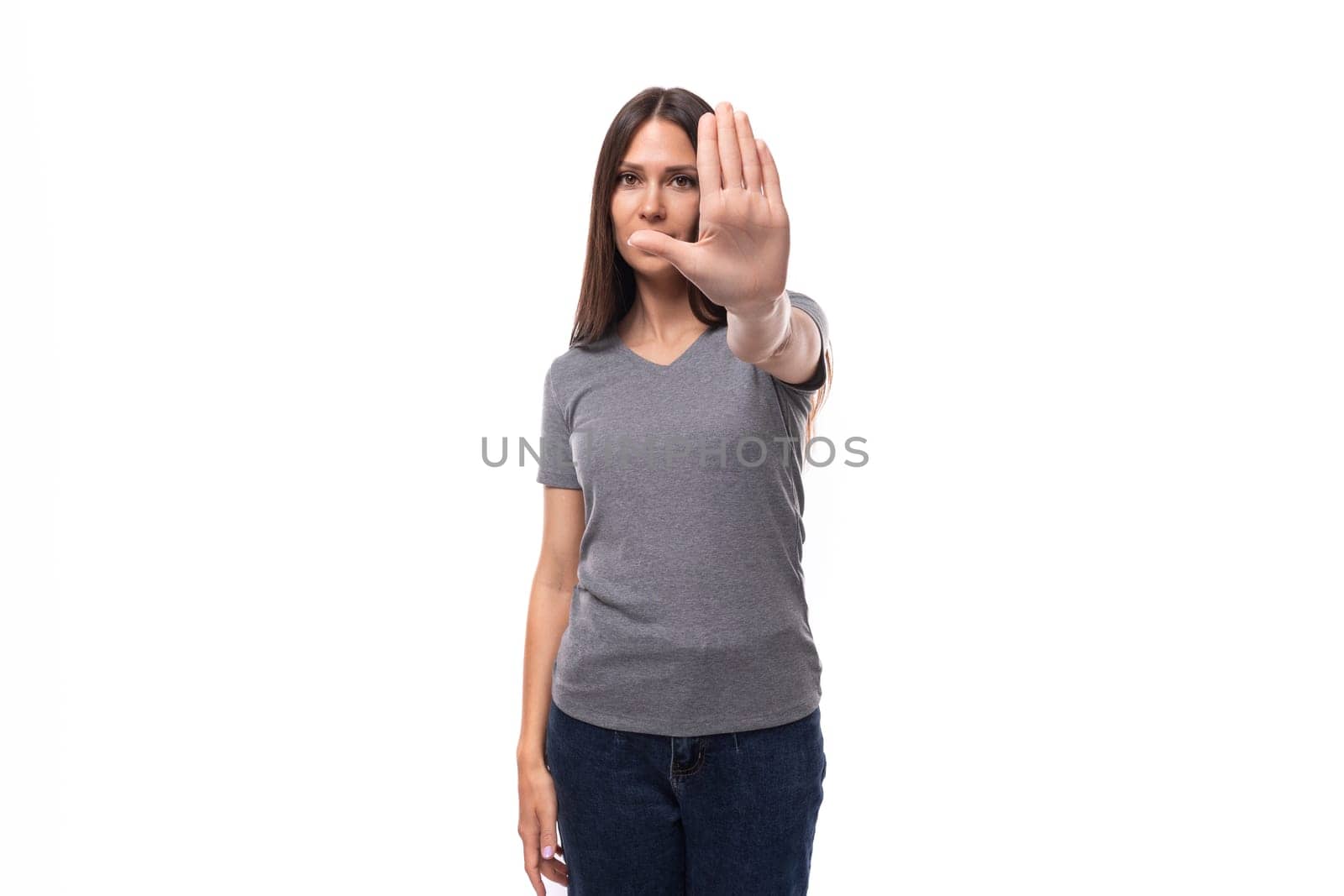young brunette promoter woman dressed in a gray t-shirt asks to stop.