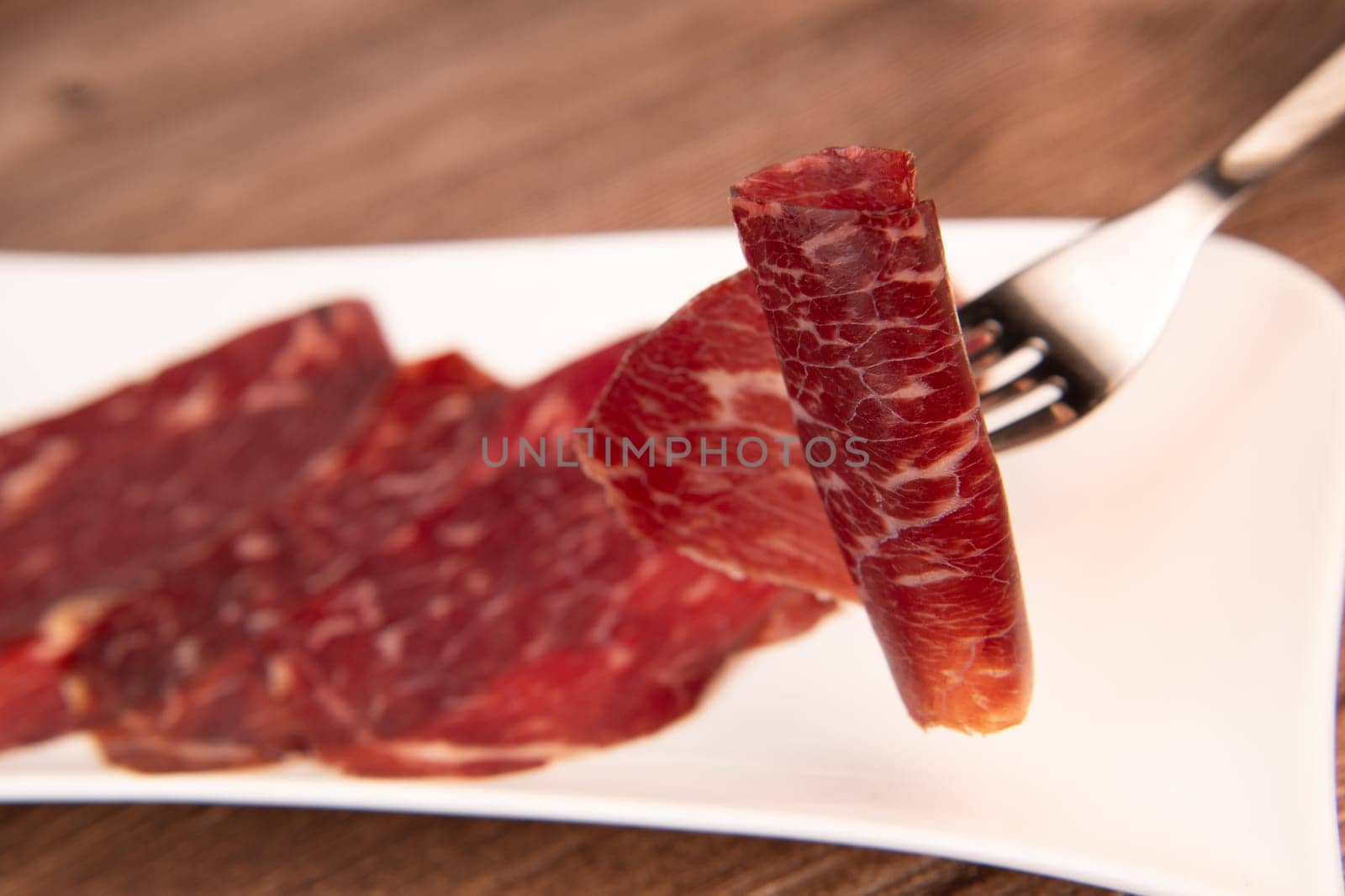 Dry-cured Spanish ham, Serrano ham, Bellota ham, Italian prosciutto crudo or Parma ham, wagyu slice. High quality photo