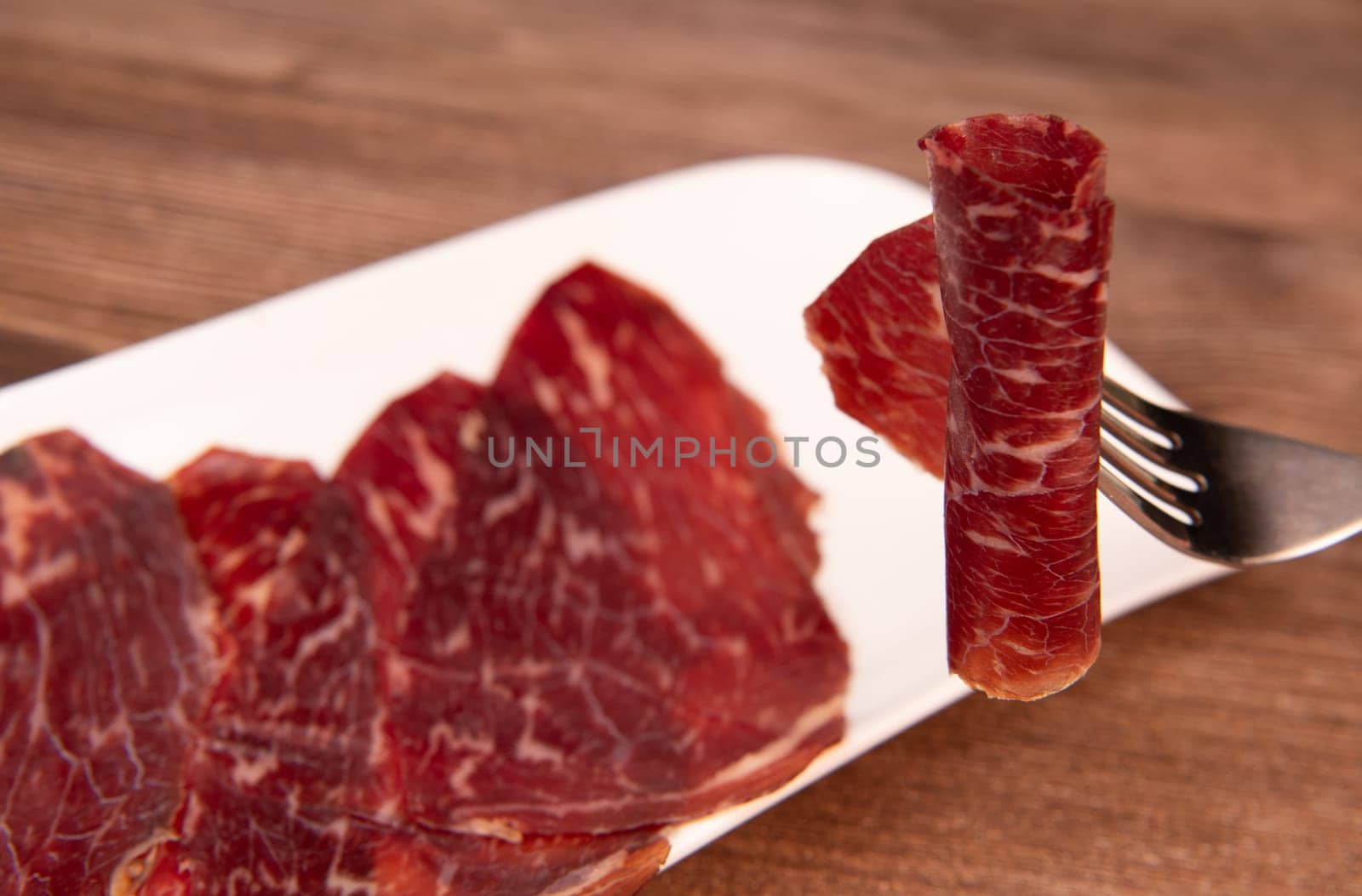 Dry-cured Spanish ham, Serrano ham, Bellota ham, Italian prosciutto crudo or Parma ham, wagyu slice. High quality photo