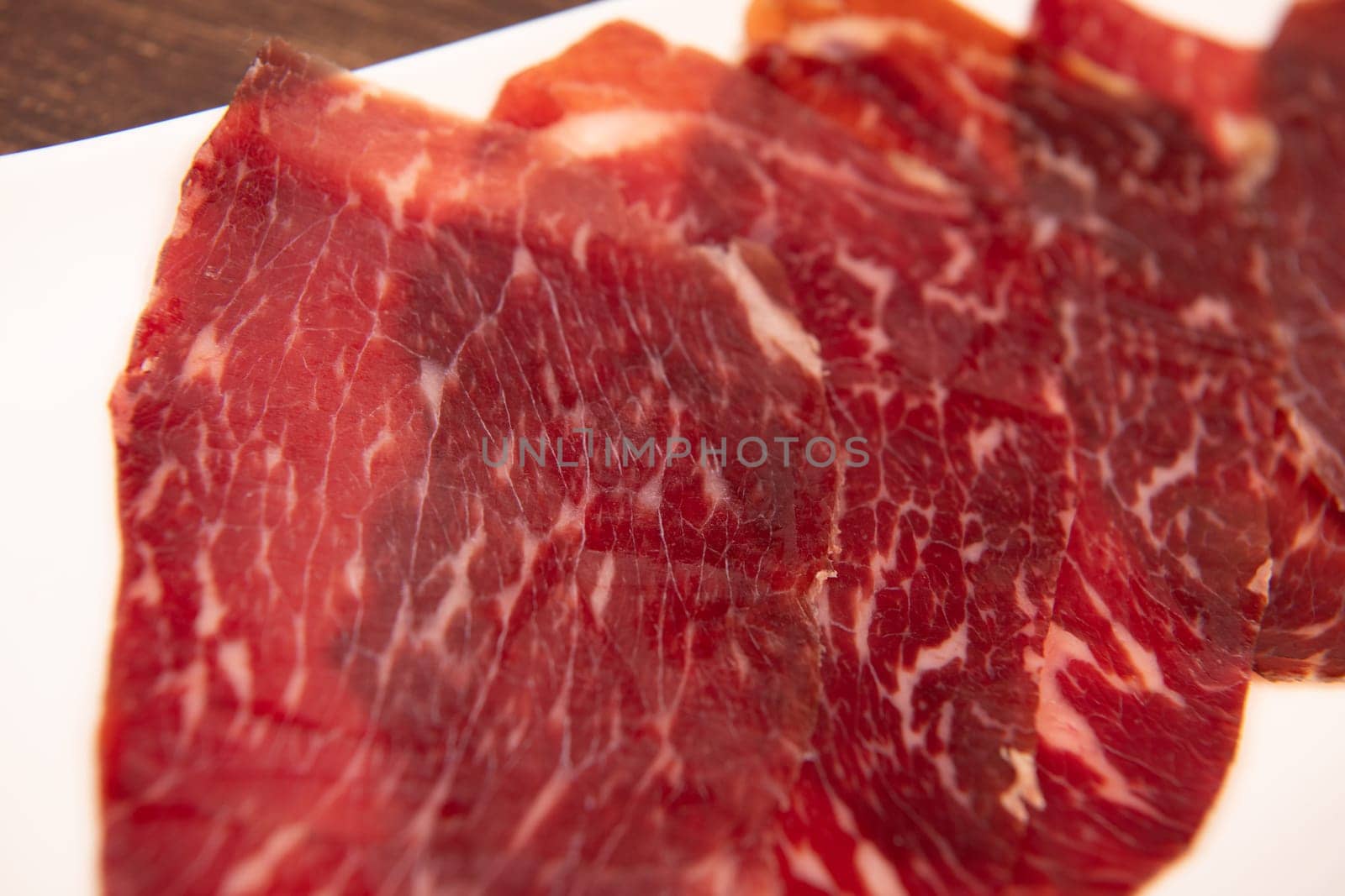 Dry-cured Spanish ham, Serrano ham, Bellota ham, Italian prosciutto crudo or Parma ham, wagyu slice. High quality photo