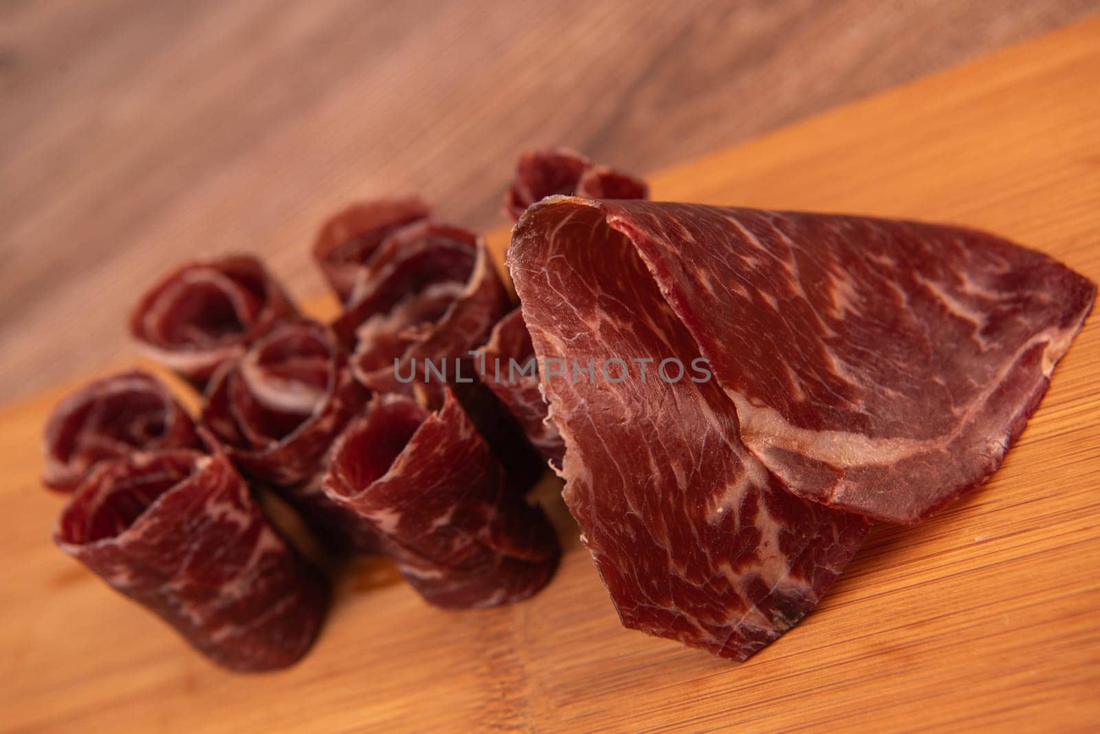 Dry-cured Spanish ham, Serrano ham, Bellota ham, Italian prosciutto crudo or Parma ham, wagyu slice. High quality photo