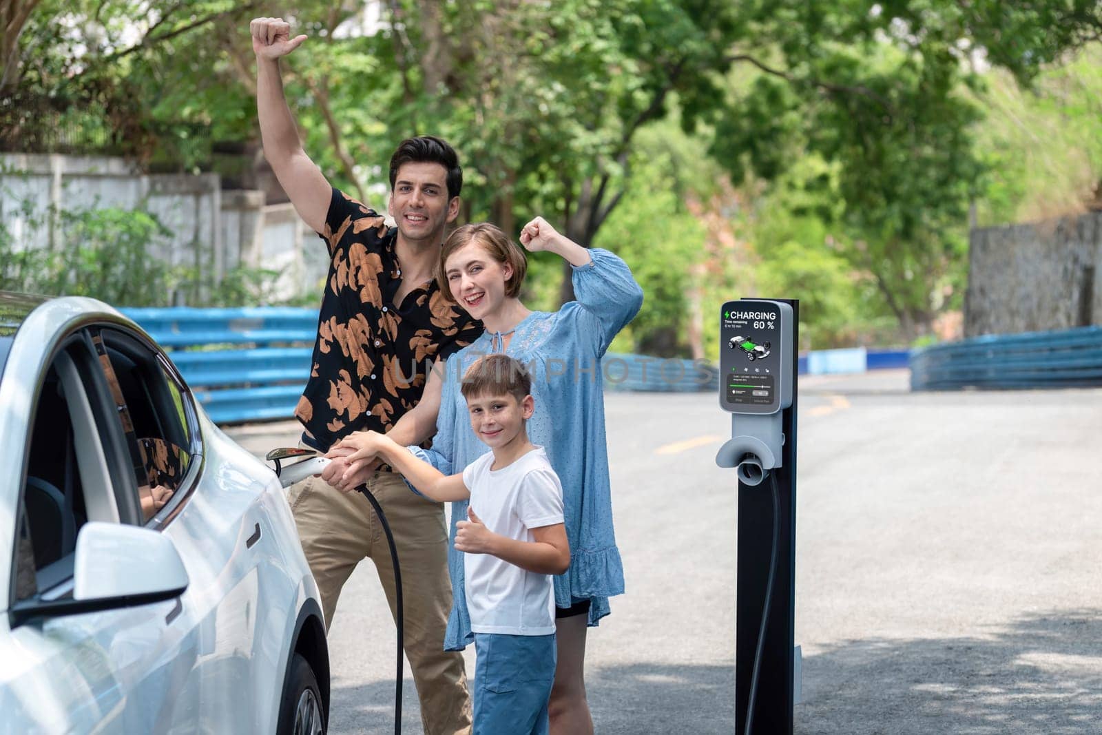 Family road trip vacation with electric vehicle, lovely family recharge EV car with green and clean energy. Natural and eco friendly car travel for sustainable environment. Perpetual