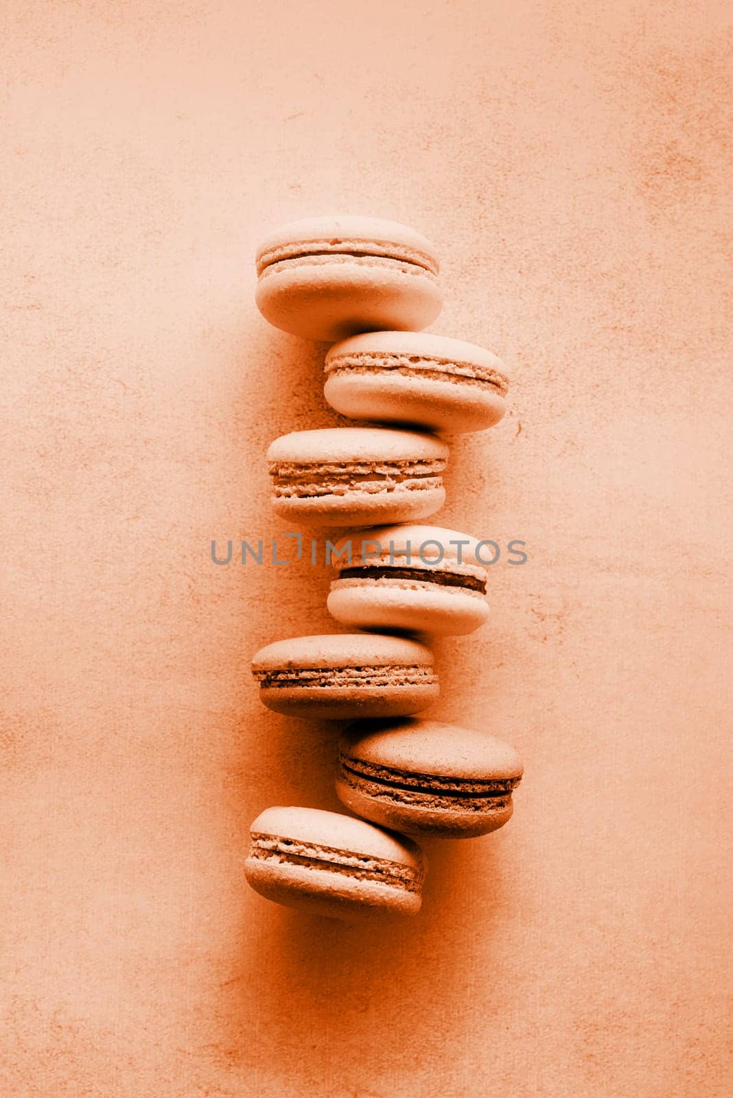 Color of the year 2024: Peach Fuzz. French dessert colorful macaroons, minimal concept flat lay. Stack of macarons, macaroons French cookie , trendy color toning