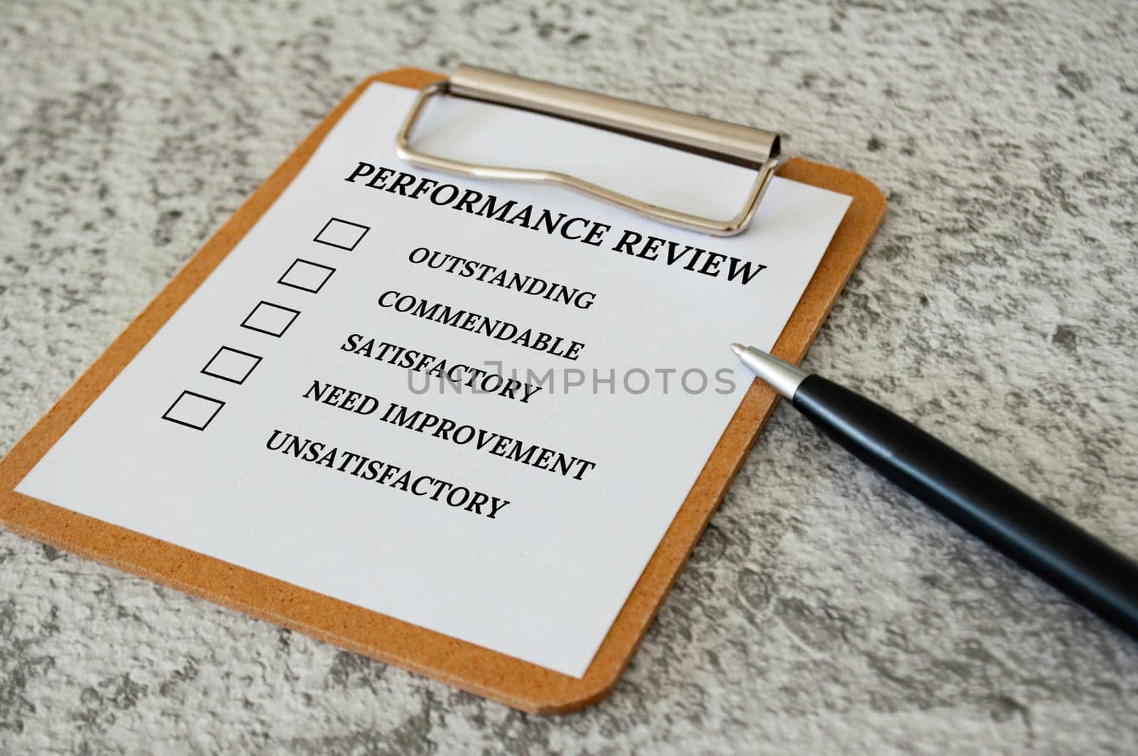Performance Review checklist on clip board with pen. Performance review concept.