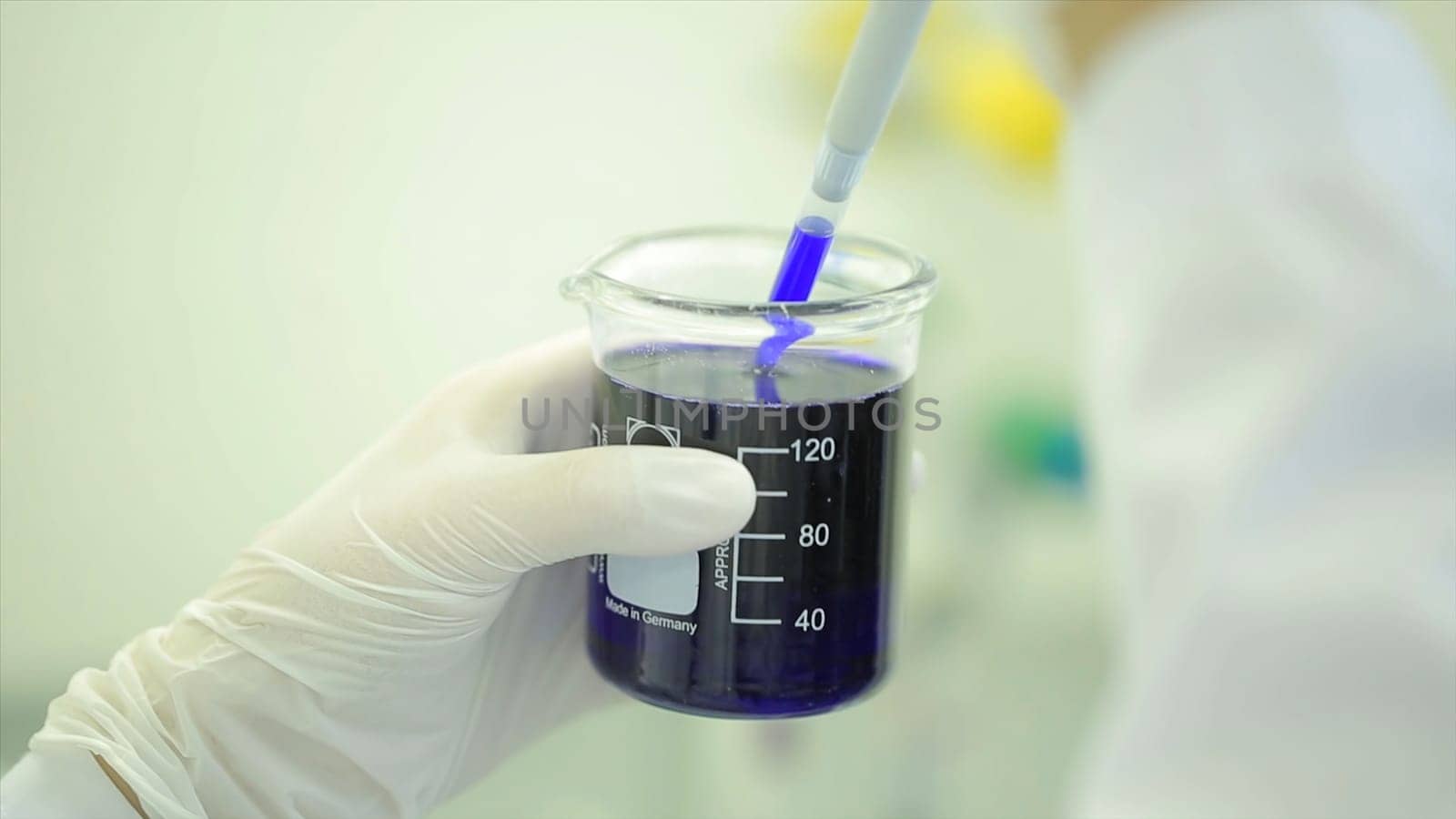 Medical staff works machine with display for control blood. Doctor at hospital checked sample in machine above view. Analysis of blood. Scientist in a laboratory. the doctor pours liquid into a test tube. Medical. Tubes. Laboratory