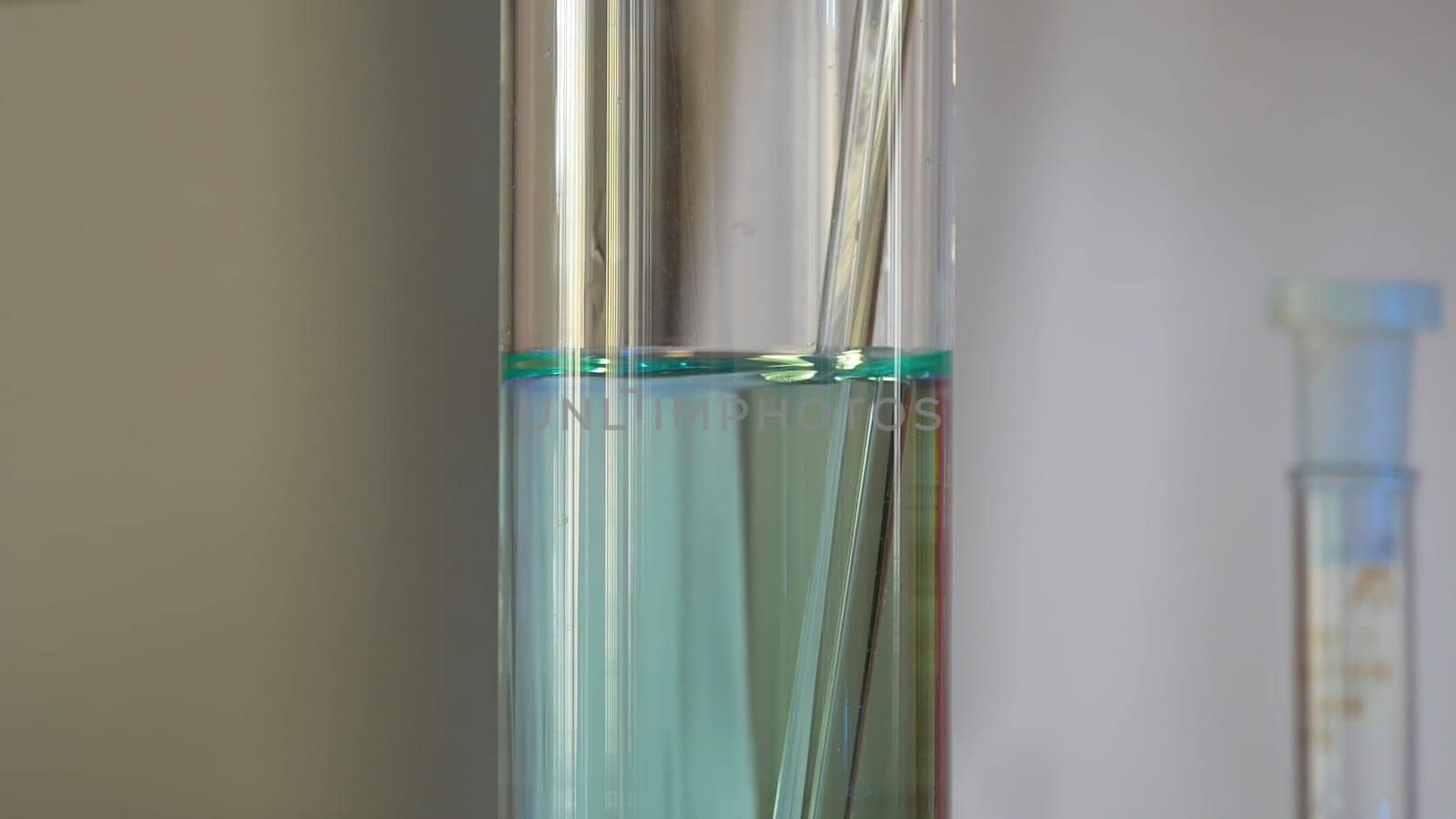 Scientist Pours Blue Pattern Chemicals Into In Flask. health care and medical concept. Scientist are certain activities on experimental science like mixing chemicals 4K