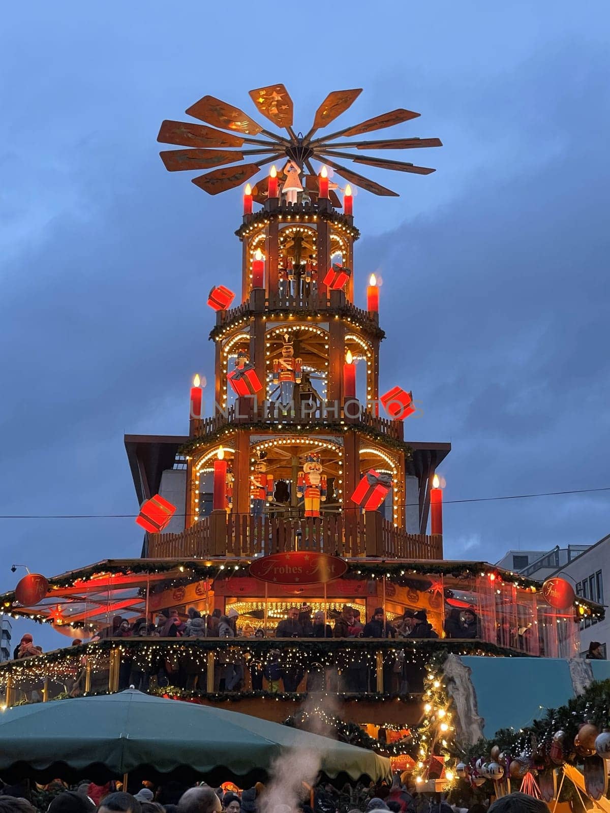 Scenic Christmas market, in the center of the Christmas market 11 december 2023, in Fulda Hesse, Germany, a building stands and glows with different lights, inviting everyone to visit it.. by Costin