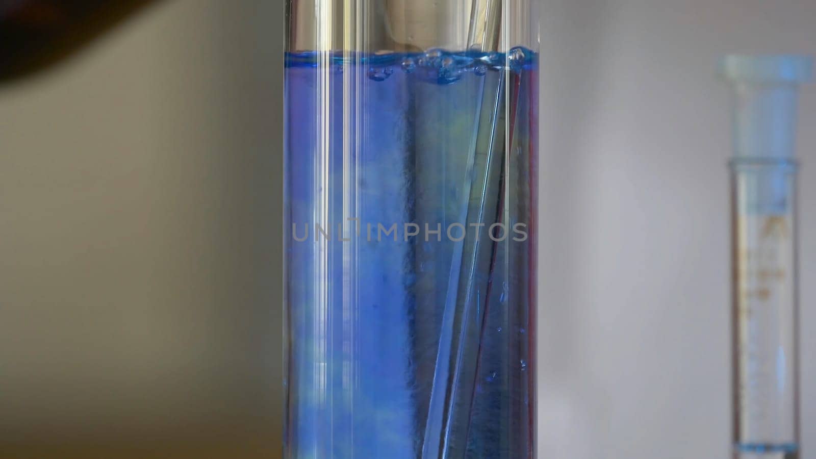 Scientist Pours Blue Pattern Chemicals Into In Flask. health care and medical concept. Scientist are certain activities on experimental science like mixing chemicals 4K
