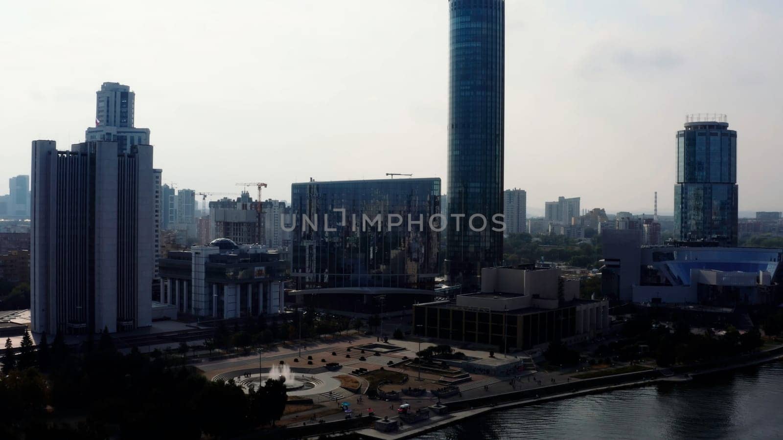 A big city with an embankment and a river. Stock footage. Bird's-eye view of tall office and residential buildings in the Art Nouveau style and the embankment for tourist walks. High quality 4k footage