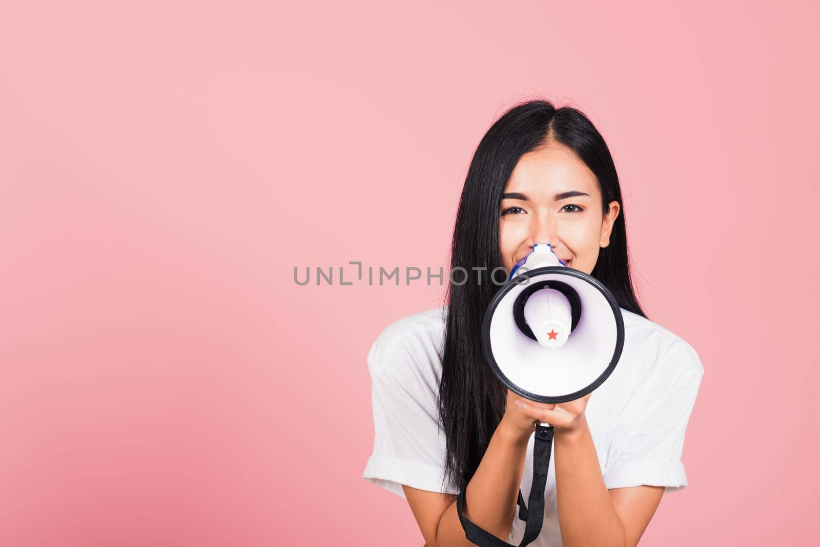 woman teen confident smiling face holding making announcement message shouting screaming in megaphone by Sorapop