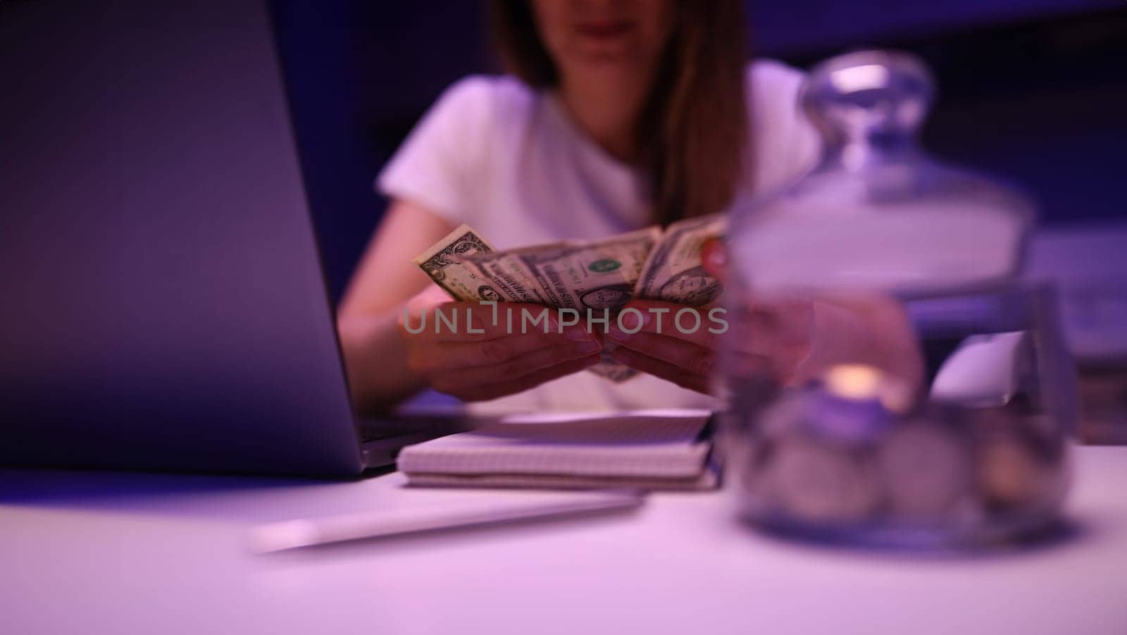 Bankrupt woman with piggy bank and dollars by kuprevich
