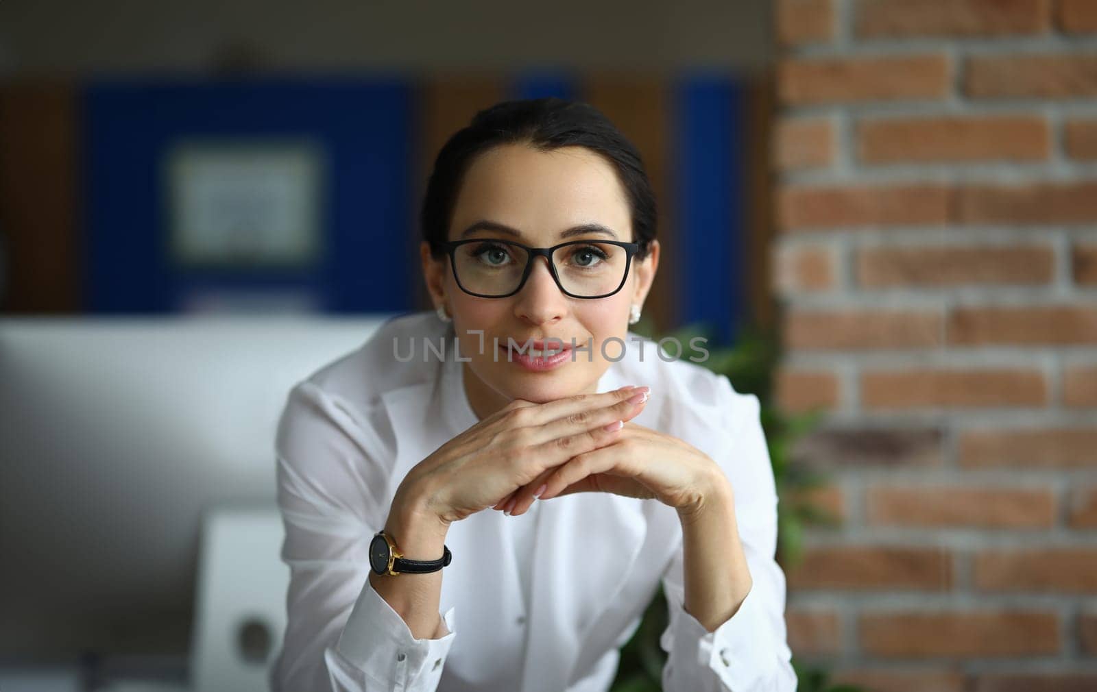Portrait of beautiful businesswoman in glasses in office. Business consultant or bank employee