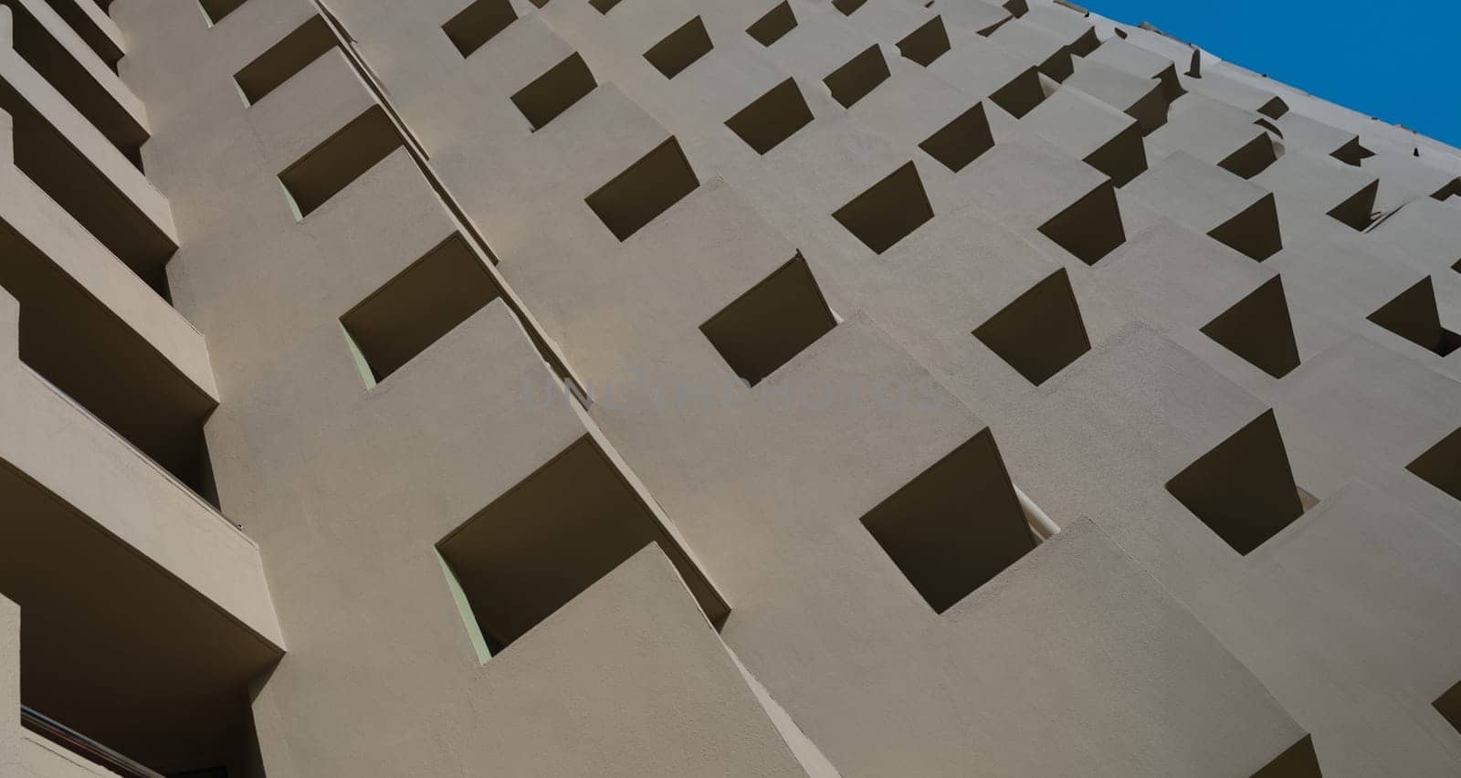 Facade of brown building with square patterns closeup background. Building design and architecture concept
