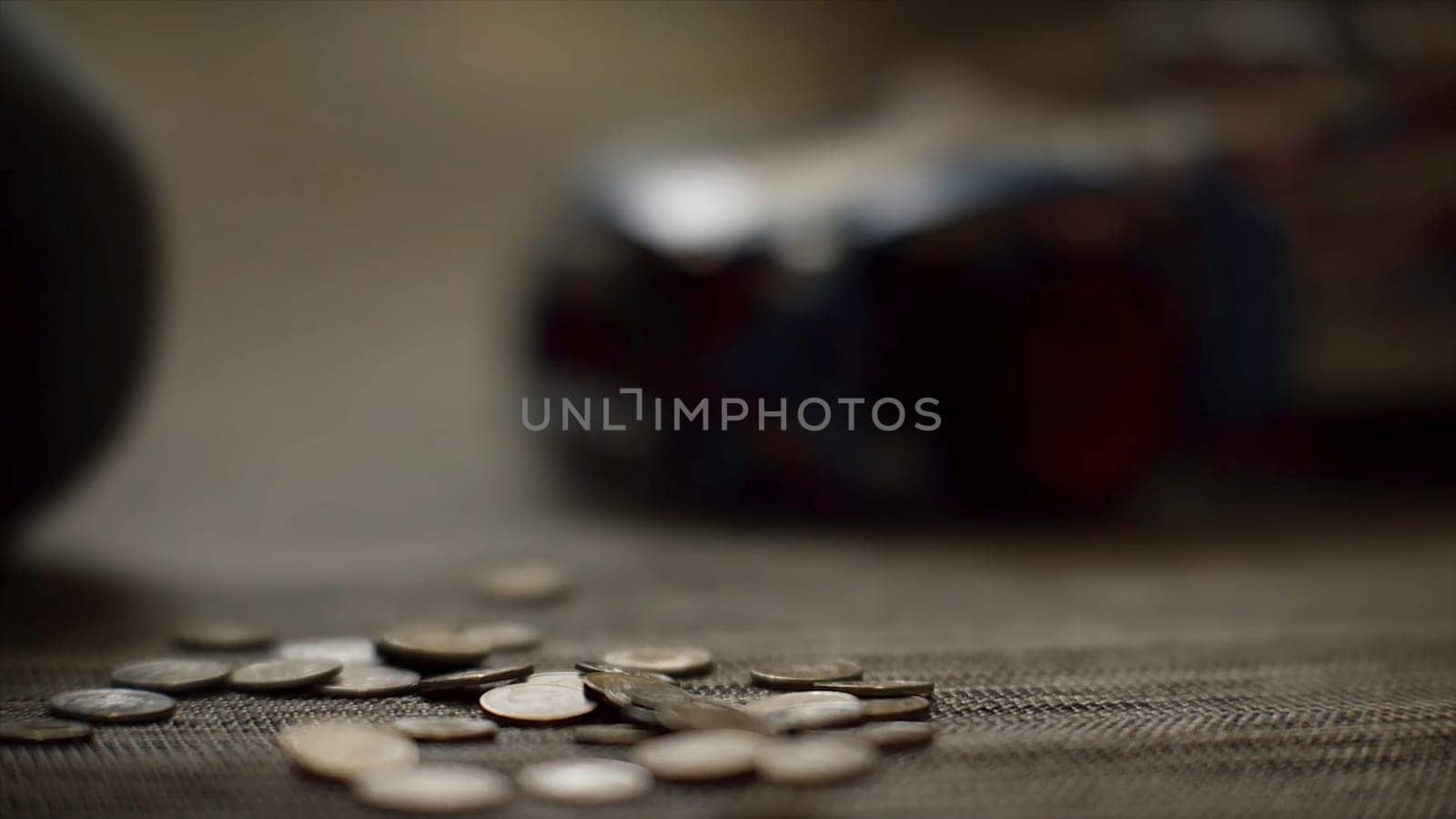 Close up for women hands putting money on the floor, saving money concept. Woman hands putting coins on the floor on blur background