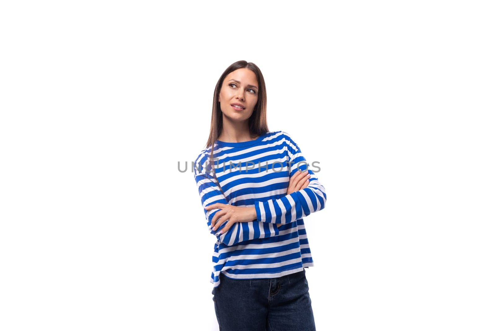 portrait of a young pretty caucasian woman with dark hair dressed in a blue striped sweatshirt on a white background. people lifestyle concept.