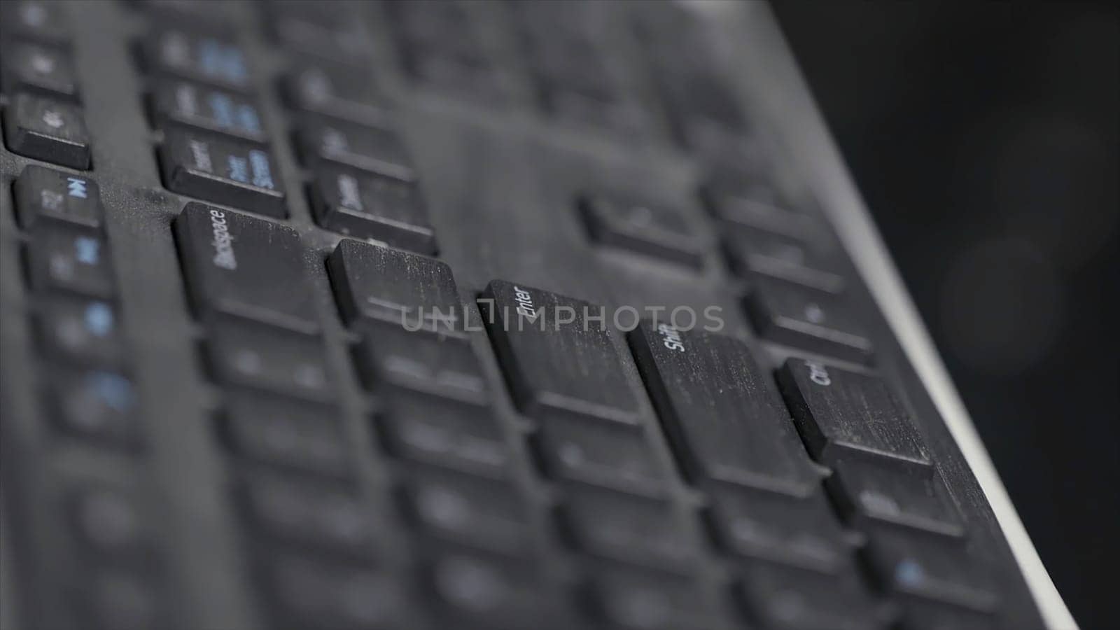 Close-up of finger over black laptop keys pressing enter button, computers and technologies concept. Man finger pushing enter key on black laptop keyboard.