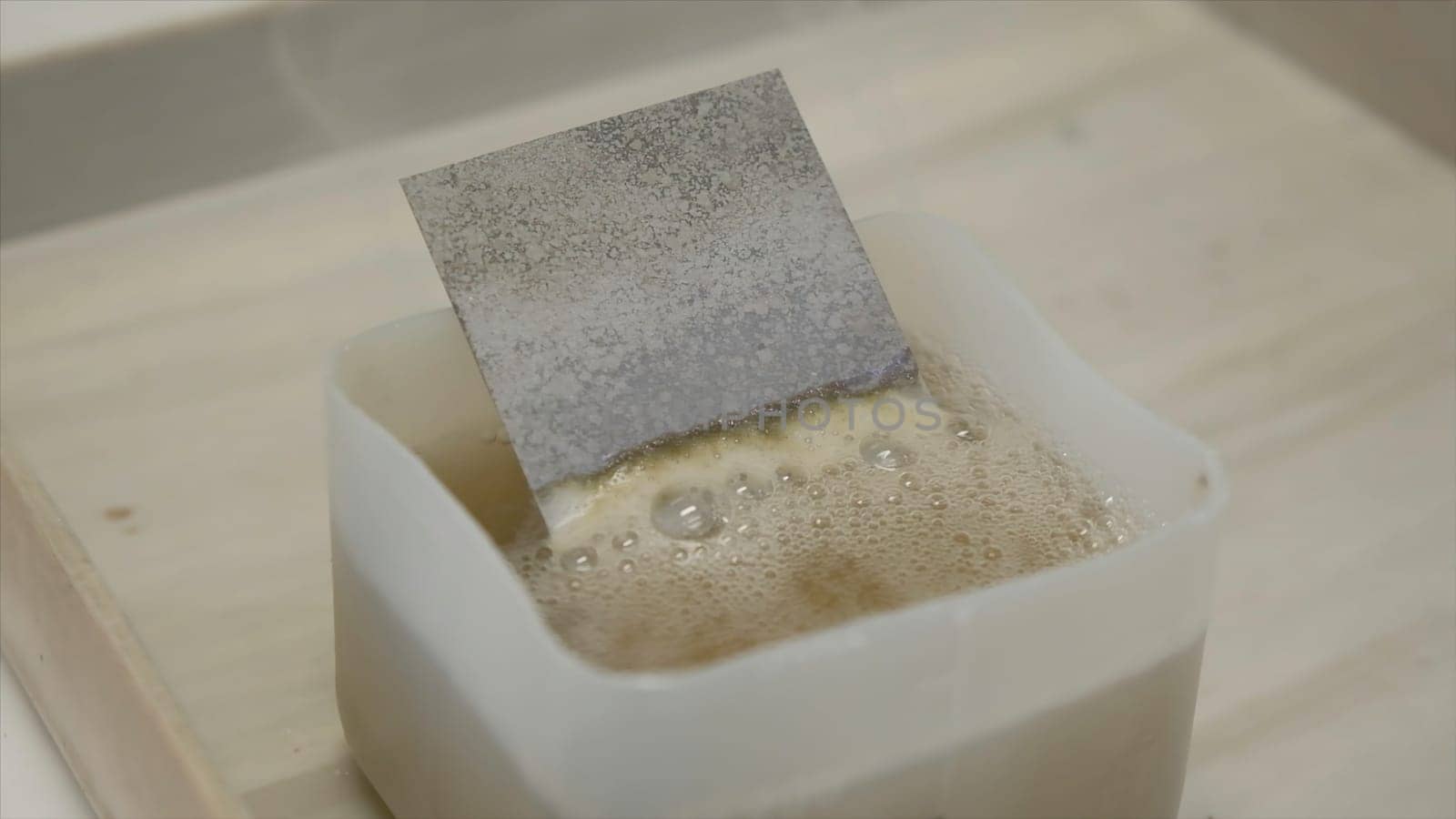 Chemical inspection of plate. Clip. Bubbling chemical liquid with metal plate. Chemical reaction with the factory part. Industrial Laboratory.