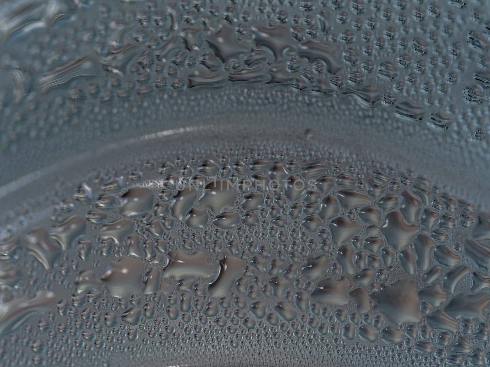 Water droplets are formed by condensation on a cold water bottle by Satakorn