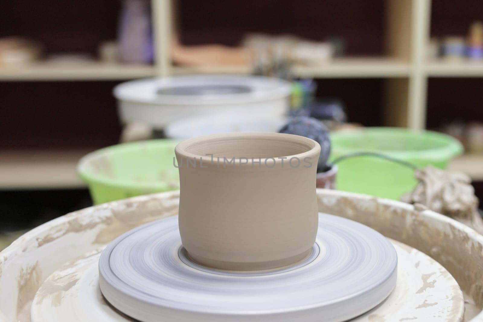 ceramic cup on on pottery wheel, Close up