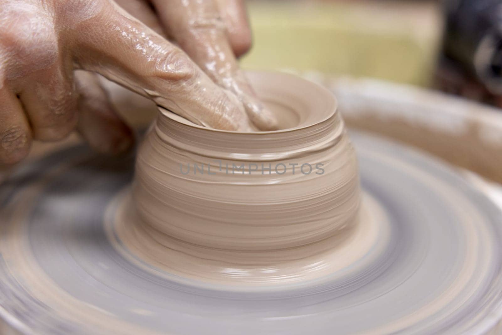 male hands making ceramic cup on pottery wheel, Close-up